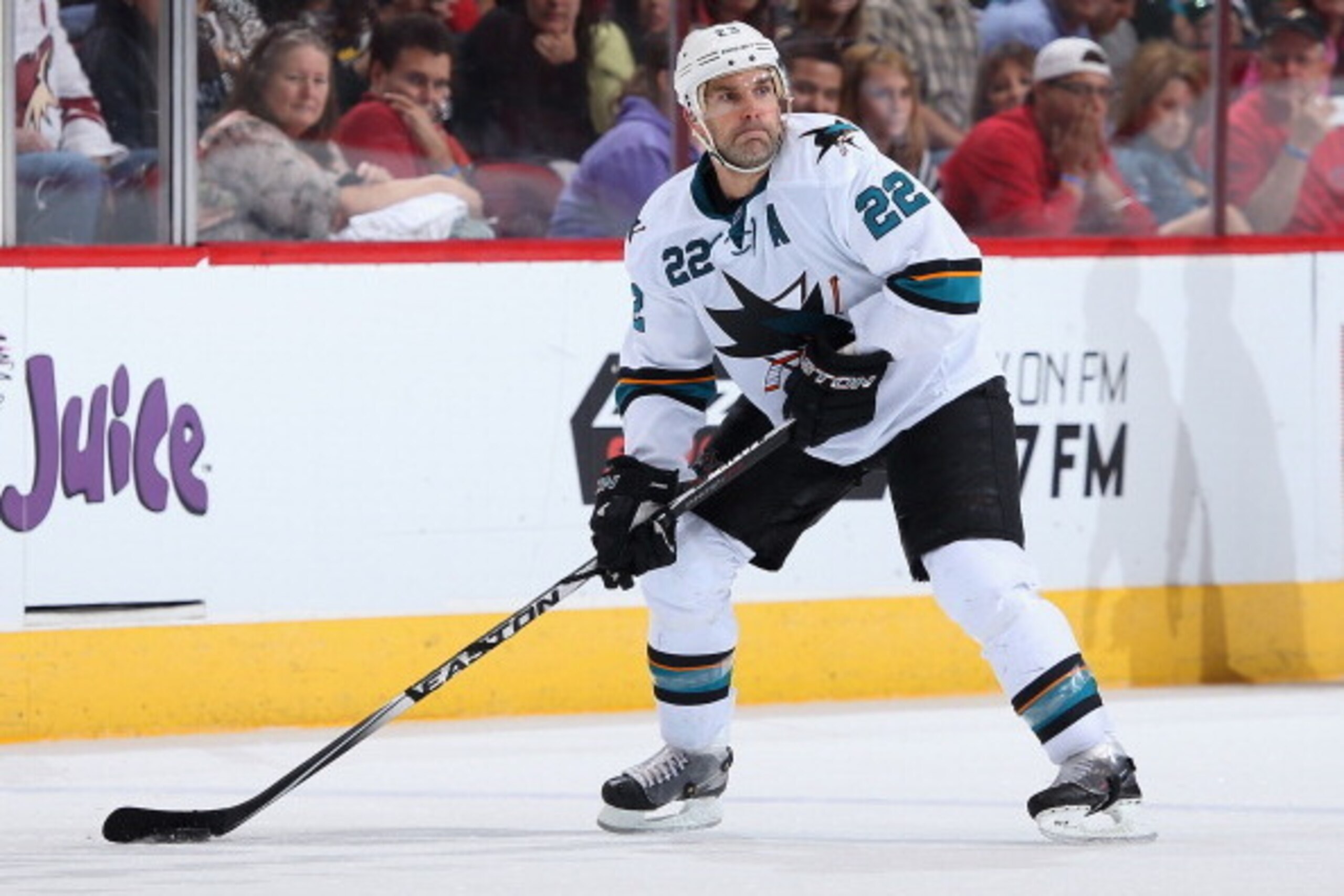 GLENDALE, AZ - APRIL 12:  Dan Boyle #22 of the San Jose Sharks skates with the puck during the NHL game against the Phoenix Coyotes at Jobing.com Arena on April 12, 2014 in Glendale, Arizona. The Sharks defeated the Coyotes 3-2.  (Photo by Christian Peter