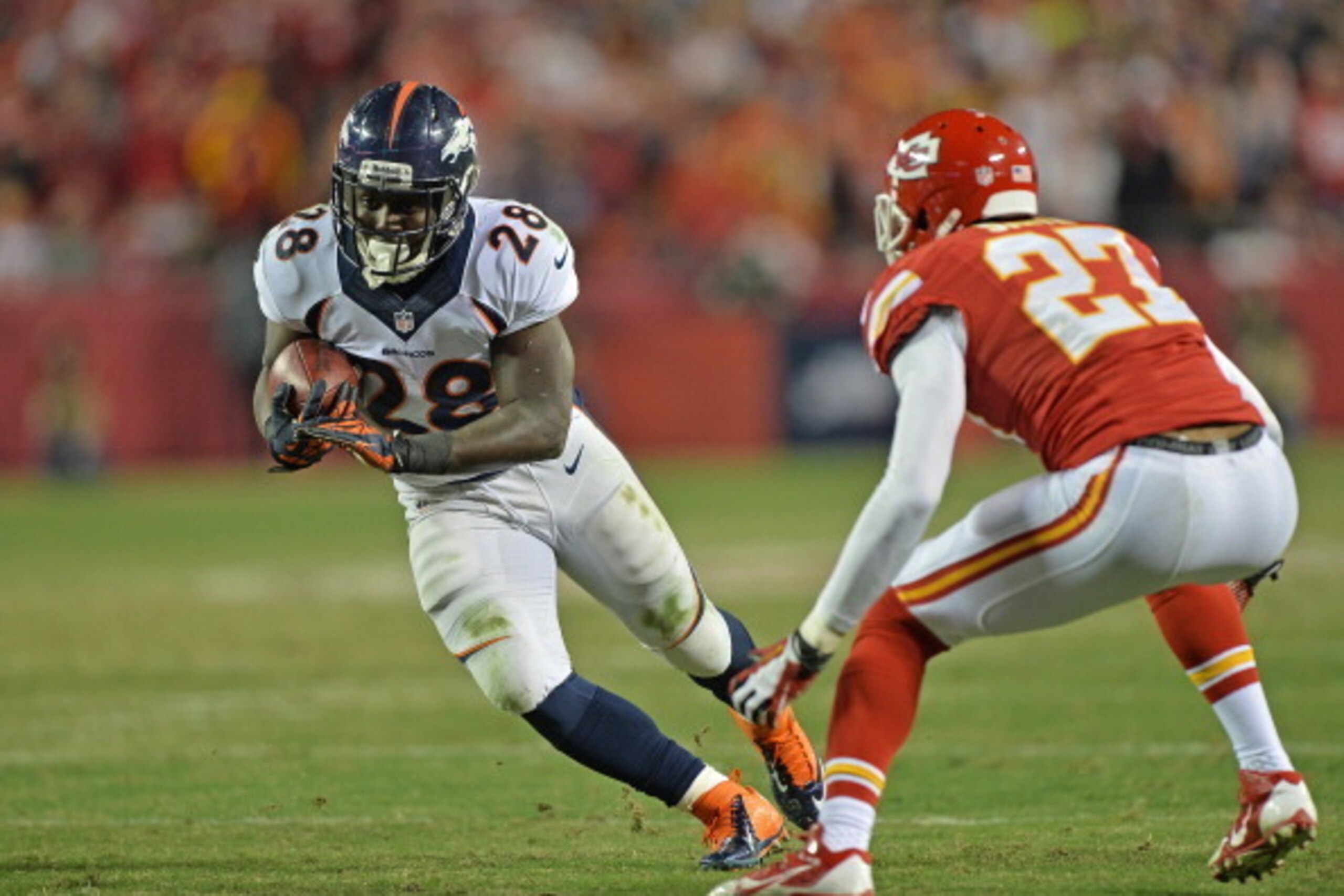 KANSAS CITY, MO - DECEMBER 01:  Running back Montee Ball #28 of the Denver Broncos rushes against defensive back Sean Smith #27 of the Kansas City Chiefs during the second half on December 1, 2013 at Arrowhead Stadium in Kansas City, Missouri.  Denver bea