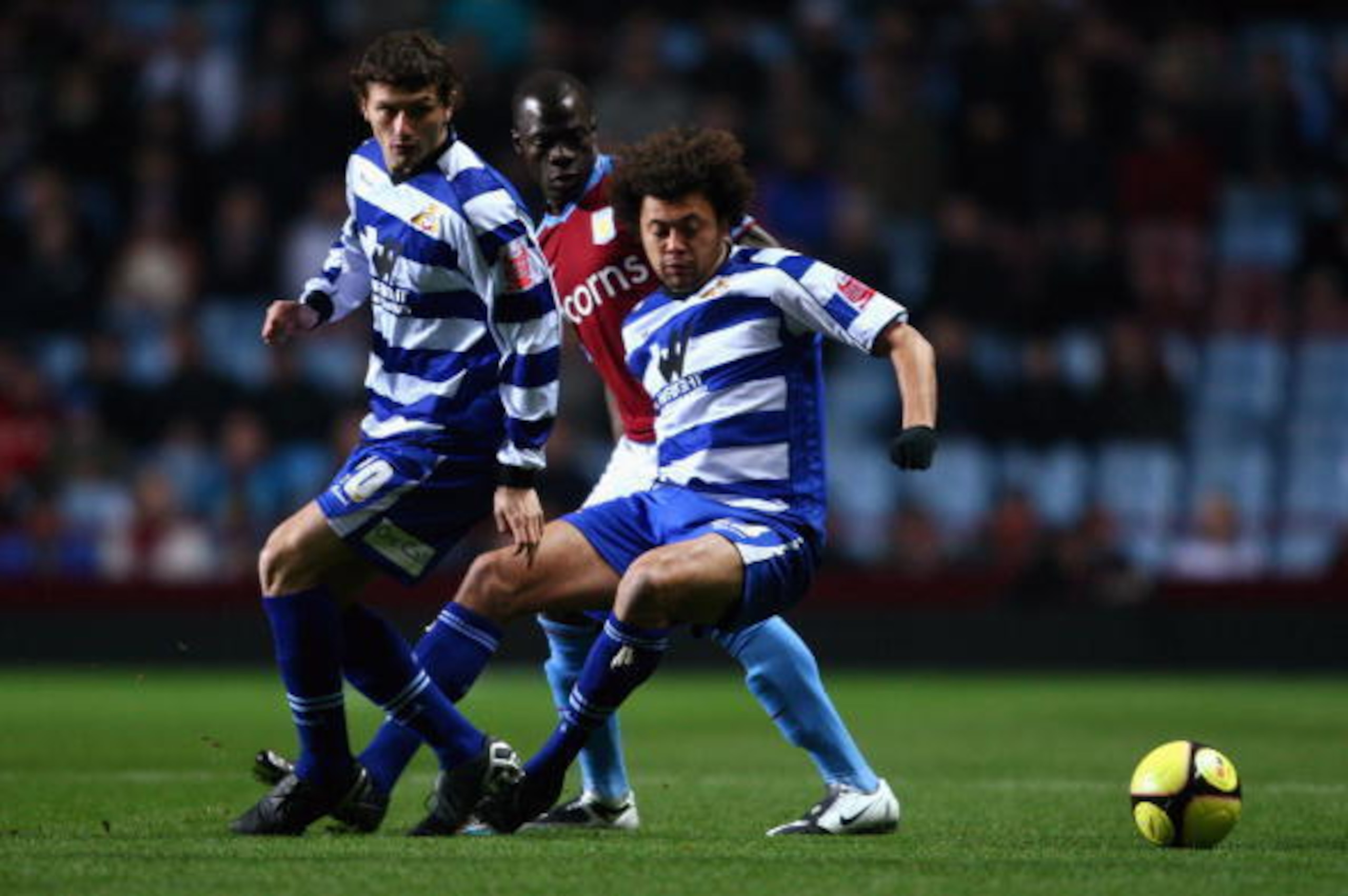 BIRMINGHAM, UNITED KINGDOM - FEBRUARY 04:  Moustapha Salifou of Aston Villa is tackled by Jason Price and John Spicer of Doncaster Rovers during the F.A Cup sponsored by E.on 4th round replay match between Aston Villa and Doncaster Rovers at Villa Park on