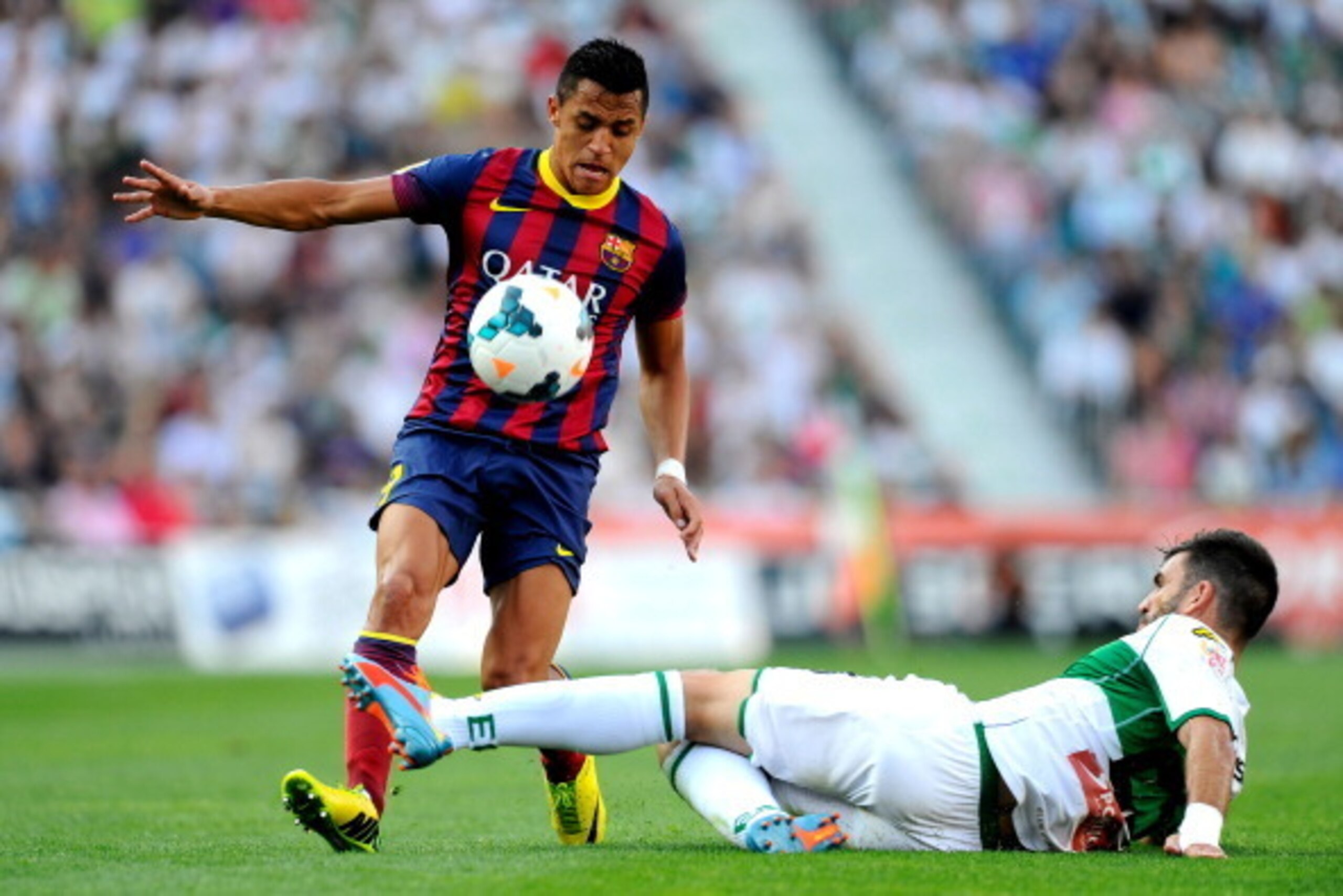ELCHE, SPAIN - MAY 11:  Alexis Sanchez of FC Barcelona competes for the ball Domingo Cisma of Elche FC during the La Liga match between Elche FC and FC Barcelona at Estadio Manuel Martinez Valero on May 11, 2014 in Elche, Spain.  (Photo by David Ramos/Get