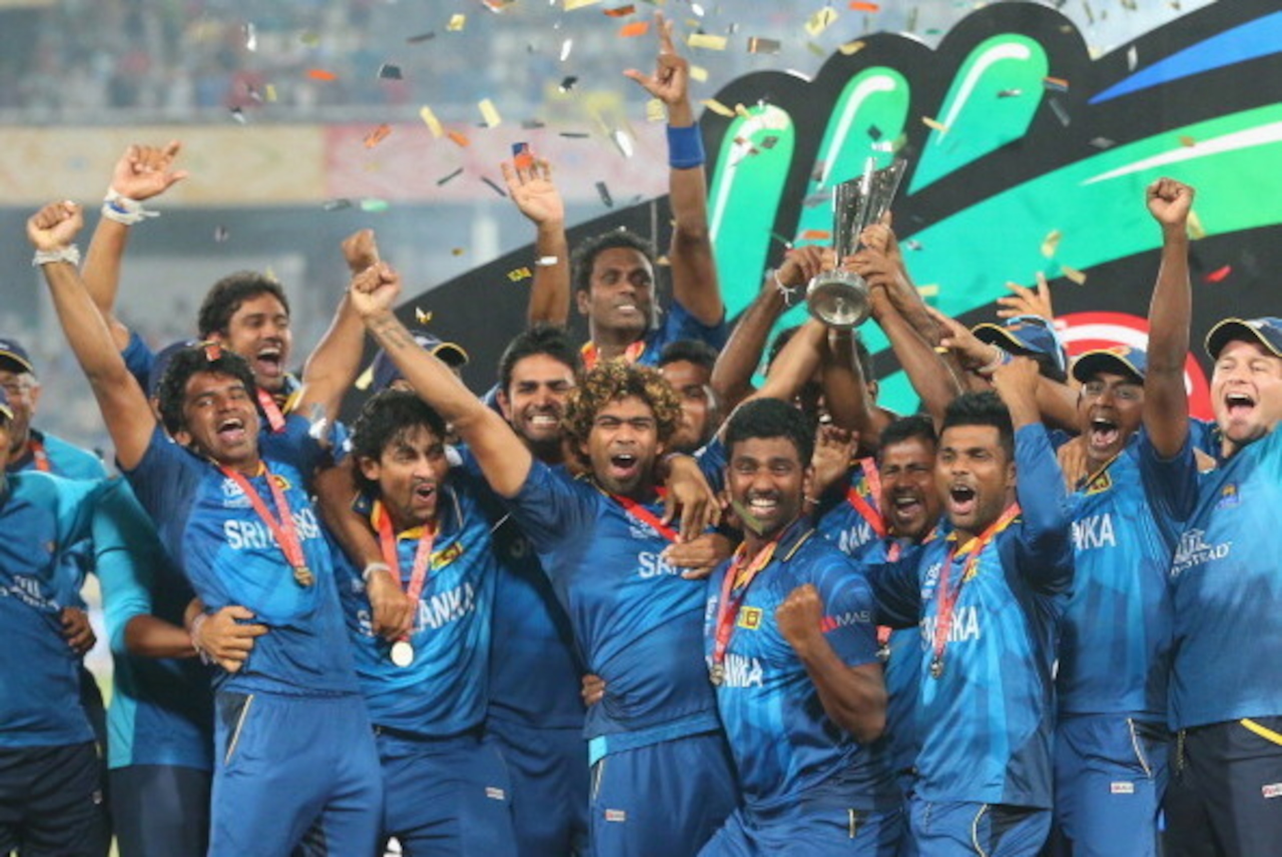DHAKA, BANGLADESH - APRIL 06:  Lasith Malinga of Sri Lanka and his team celebrate with the trophy on the podium after winning the Final of the ICC World Twenty20 Bangladesh 2014 between India and Sri Lanka at Sher-e-Bangla Mirpur Stadium on April 4, 2014 