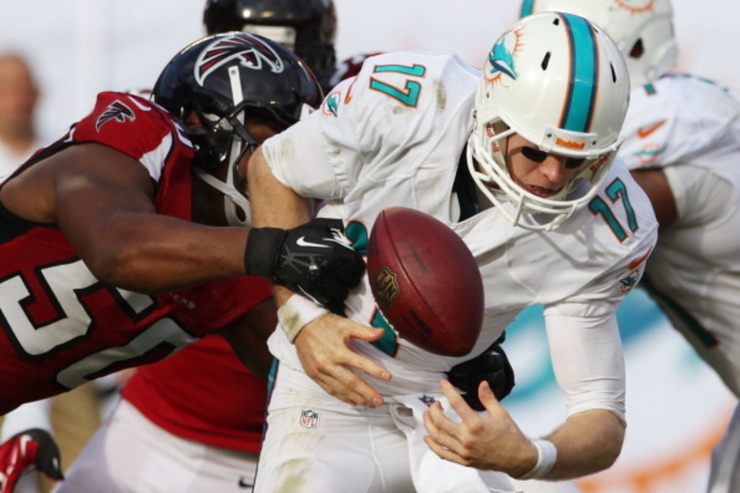 MIAMI GARDENS, FL - SEPTEMBER 22:  Quarterback Ryan Tannehill #17 of the Miami Dolphins is sacked by Defensive lineman Osi Umenyiora #50 of the Atlanta Falcons and fumbles the ball at Sun Life Stadium on September 22, 2013 in Miami Gardens, Florida. The D