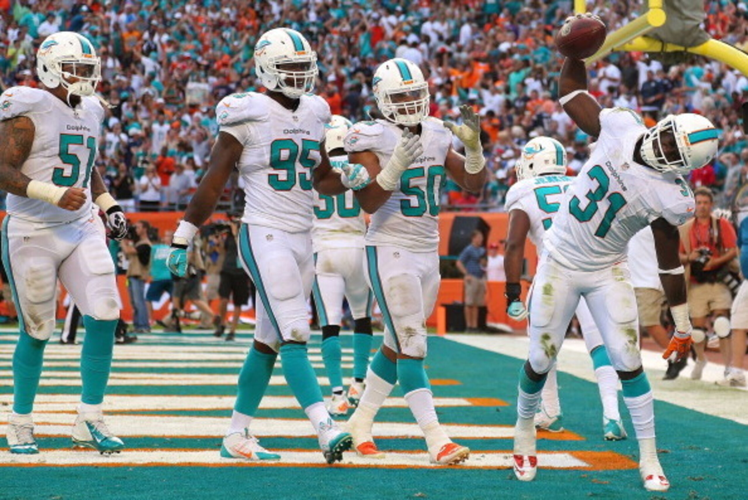 MIAMI GARDENS, FL - DECEMBER 15:  Michael Thomas #31 of the Miami Dolphins celebrates a game clinching interception during a game against the New England Patriots at Sun Life Stadium on December 15, 2013 in Miami Gardens, Florida.  (Photo by Mike Ehrmann/