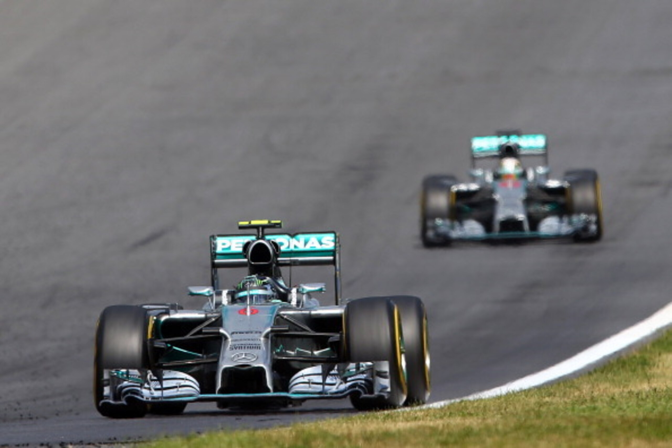 SPIELBERG, AUSTRIA - JUNE 22:  Nico Rosberg of Germany and Mercedes GP leads Lewis Hamilton of Great Britain and Mercedes GP during the Austrian Formula One Grand Prix at Red Bull Ring on June 22, 2014 in Spielberg, Austria.  (Photo by Mark Thompson/Getty