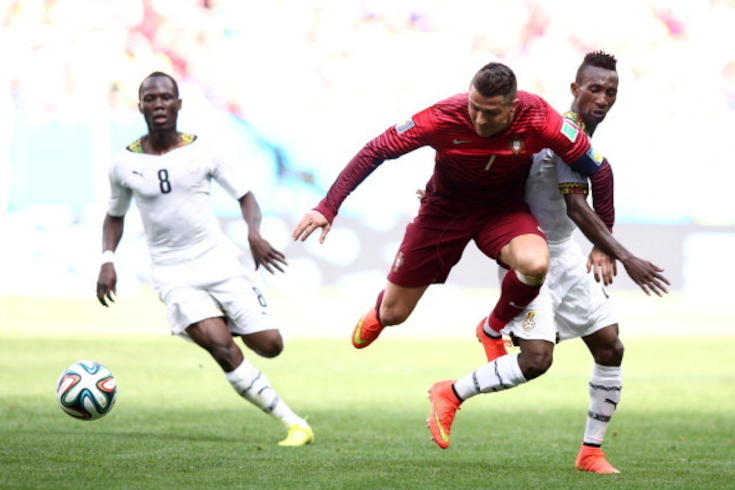 BRASILIA, BRAZIL - JUNE 26:  Cristiano Ronaldo of Portugal is challenged by Harrison Afful of Ghana during the 2014 FIFA World Cup Brazil Group G match between Portugal and Ghana at Estadio Nacional on June 26, 2014 in Brasilia, Brazil.  (Photo by Adam Pr