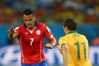 CUIABA, BRAZIL - JUNE 13: Tommy Oar of Australia tackles Alexis Sanchez of Chile during the 2014 FIFA World Cup Brazil Group B match between Chile and Australia at Arena Pantanal on June 13, 2014 in Cuiaba, Brazil.  (Photo by Clive Brunskill/Getty Images)