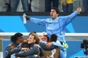 Jun 19, 2014; Sao Paulo, BRAZIL; Uruguay forward Luis Suarez (9) is lifted by his teammates as they celebrate following the game against England during the 2014 World Cup at Arena Corinthians. Uruguay  defeated England 2-1. Mandatory Credit: Mark J. Rebil