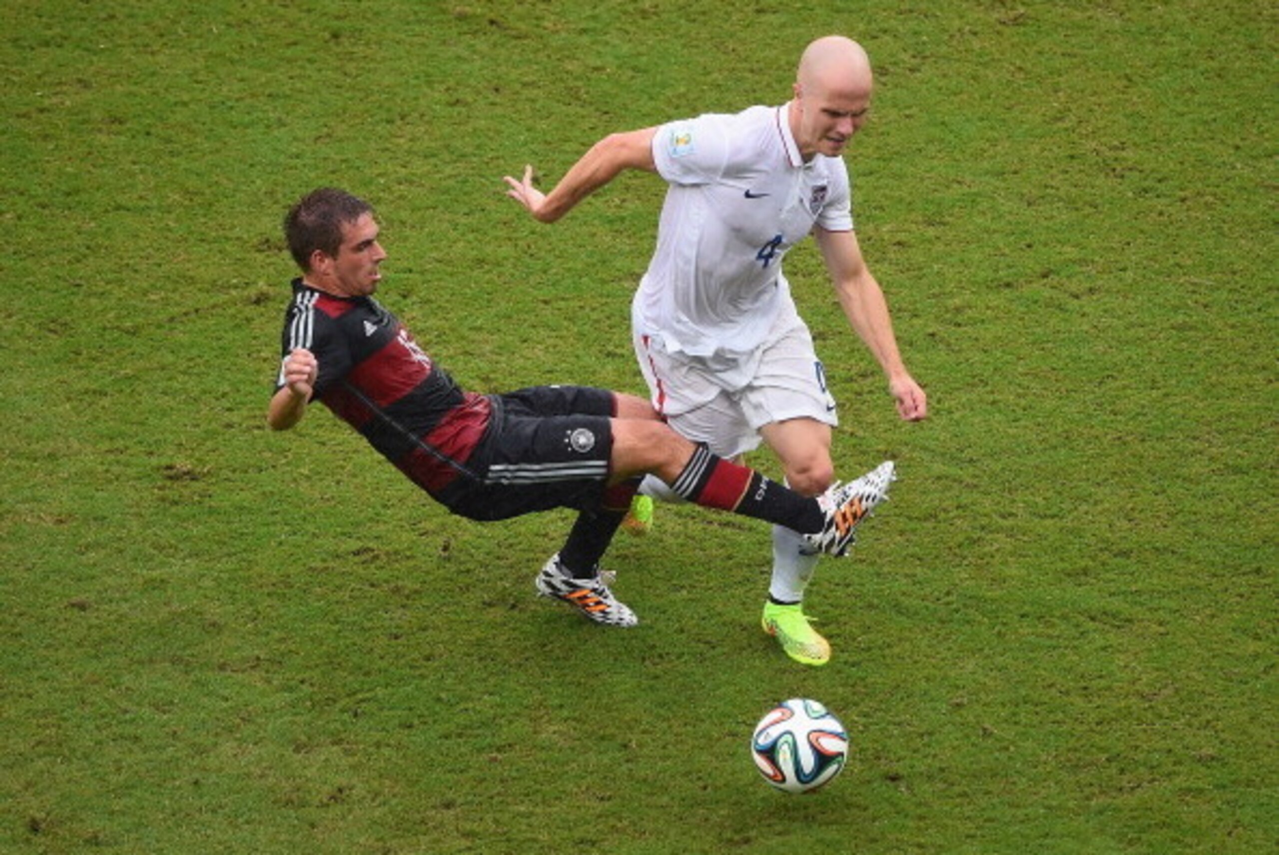 RECIFE, BRAZIL - JUNE 26:  Philipp Lahm of Germany challenges Michael Bradley of the United States during the 2014 FIFA World Cup Brazil group G match between the United States and Germany at Arena Pernambuco on June 26, 2014 in Recife, Brazil.  (Photo by