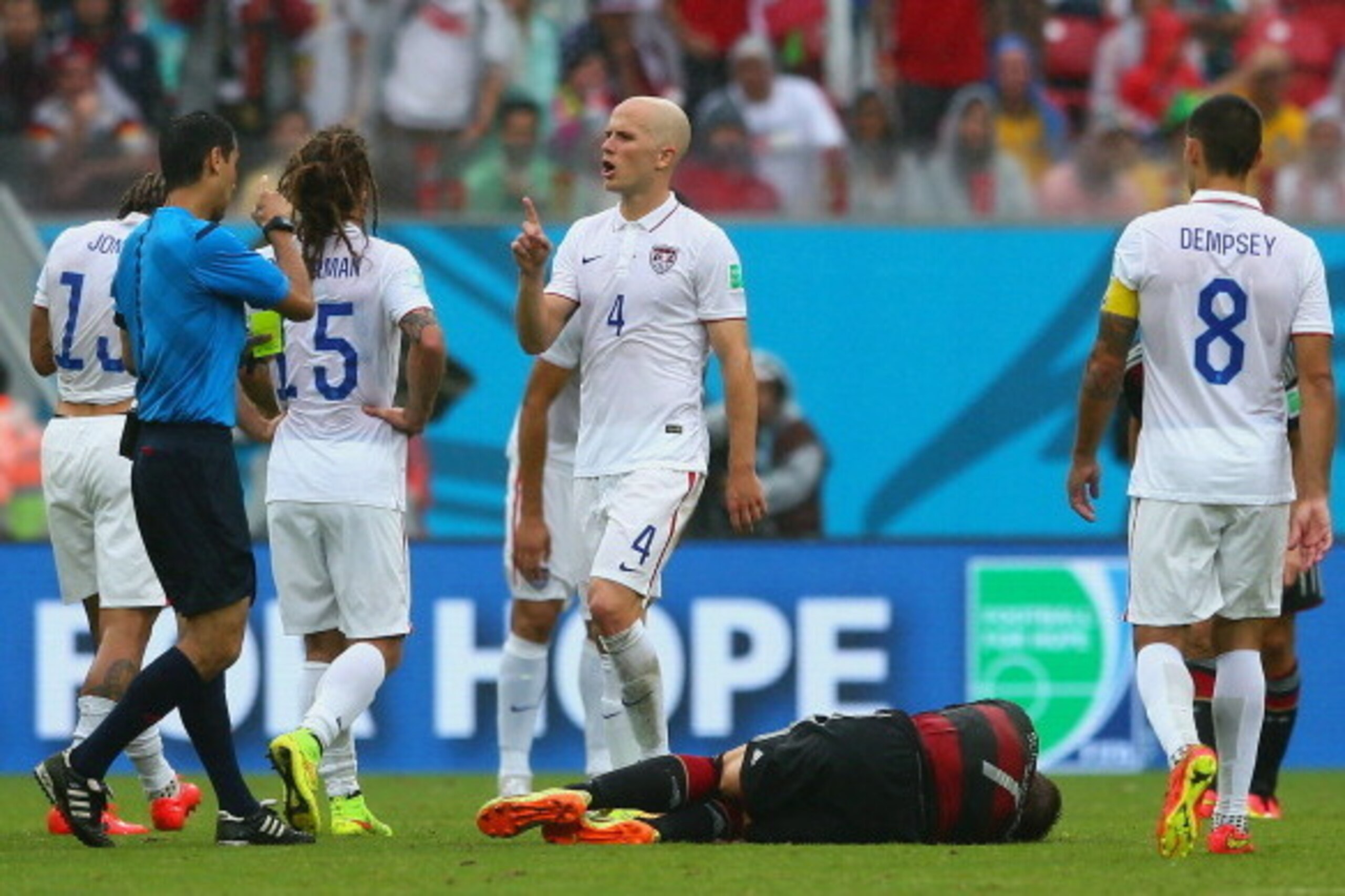 RECIFE, BRAZIL - JUNE 26: Referee Ravshan Irmatov speaks to Michael Bradley of the United States during the 2014 FIFA World Cup Brazil group G match between the United States and Germany at Arena Pernambuco on June 26, 2014 in Recife, Brazil.  (Photo by K