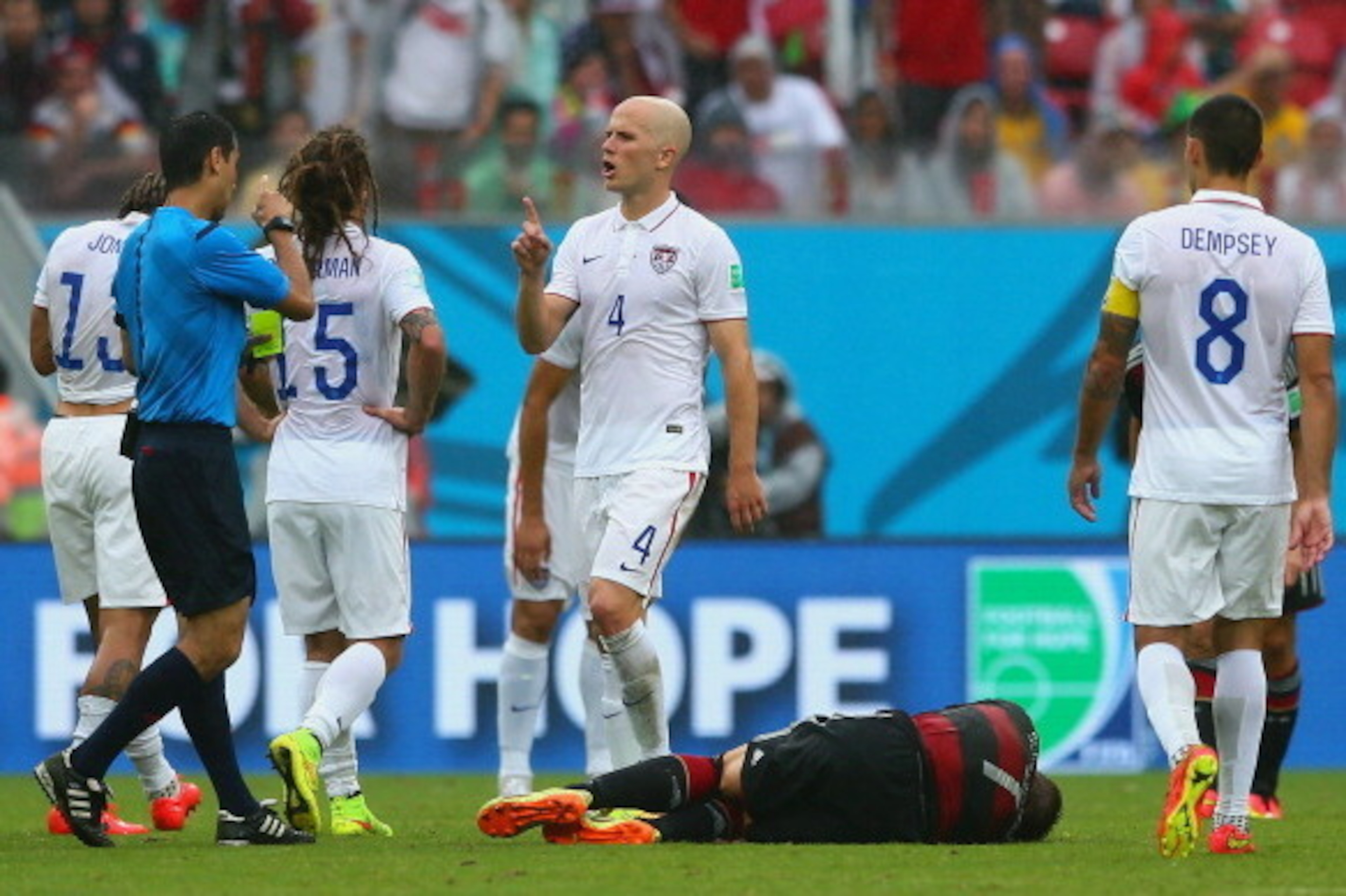 RECIFE, BRAZIL - JUNE 26: Referee Ravshan Irmatov speaks to Michael Bradley of the United States during the 2014 FIFA World Cup Brazil group G match between the United States and Germany at Arena Pernambuco on June 26, 2014 in Recife, Brazil.  (Photo by K