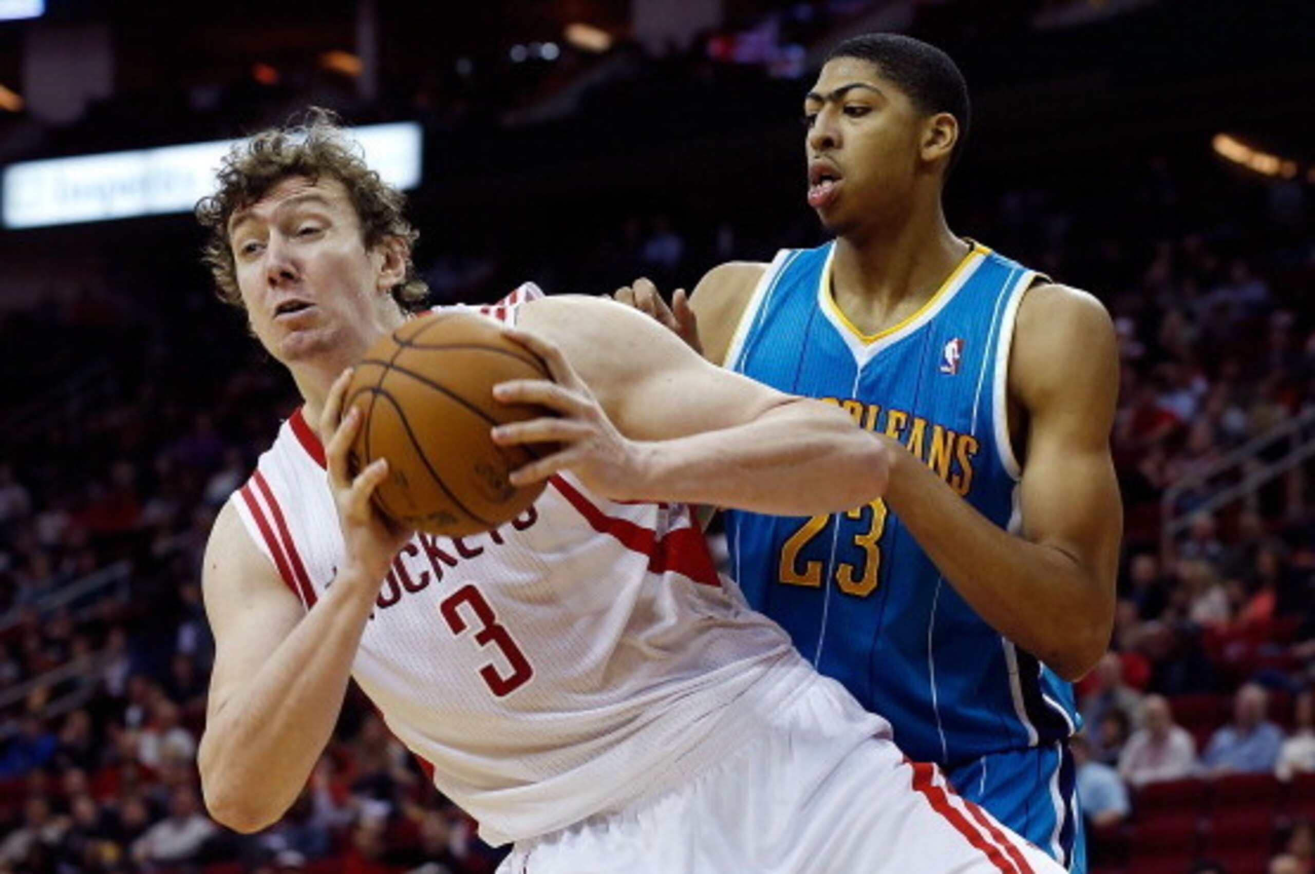 HOUSTON, TX - JANUARY 02:  Omer Asik #3 of the Houston Rockets grabs a rebound in front of Anthony Davis #23 of the New Orleans Hornets at Toyota Center on January 2, 2013 in Houston, Texas.  NOTE TO USER: User expressly acknowledges and agrees that, by d