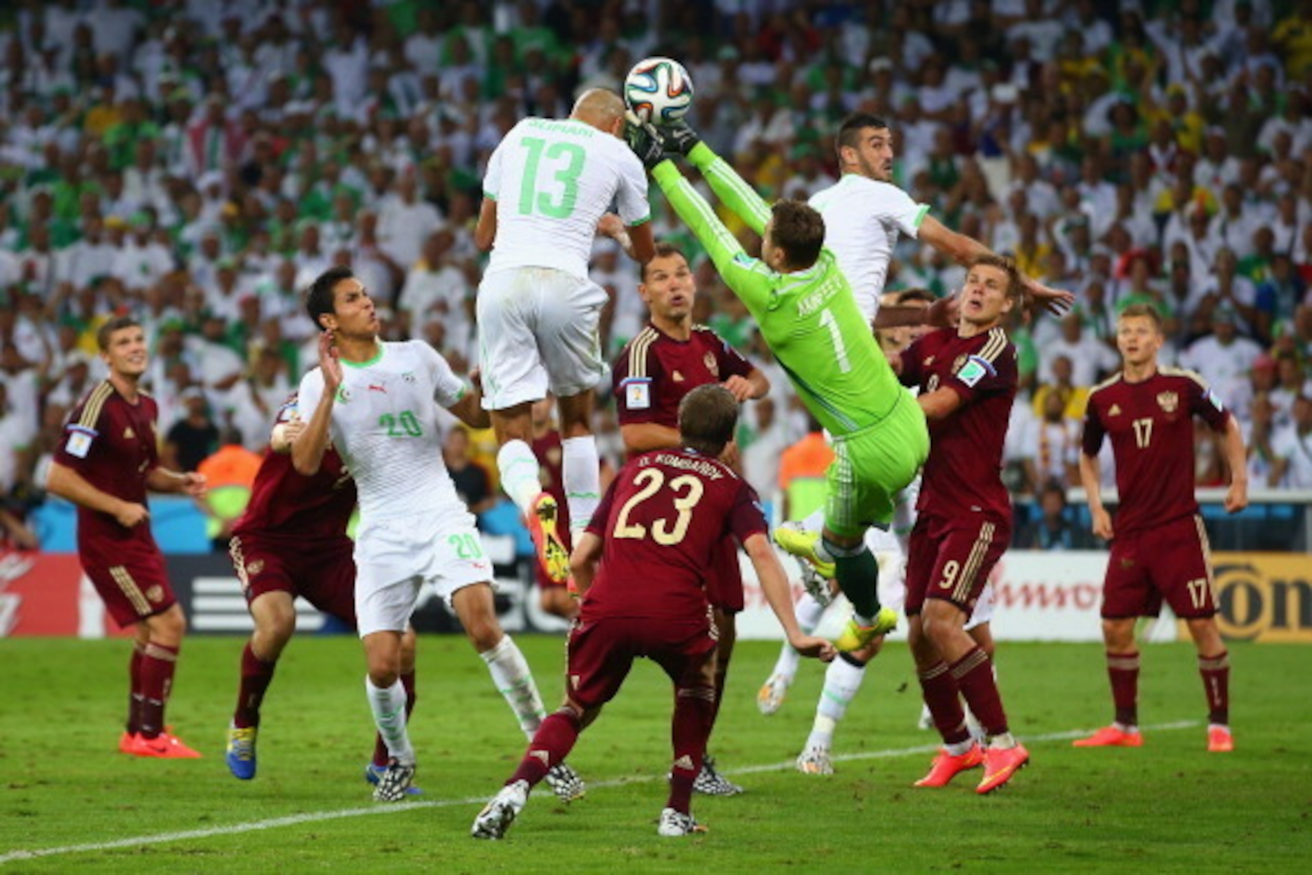 CURITIBA, BRAZIL - JUNE 26:  Islam Slimani of Algeria scores his team's first goal on a header past Igor Akinfeev of Russia during the 2014 FIFA World Cup Brazil Group H match between Algeria and Russia at Arena da Baixada on June 26, 2014 in Curitiba, Br
