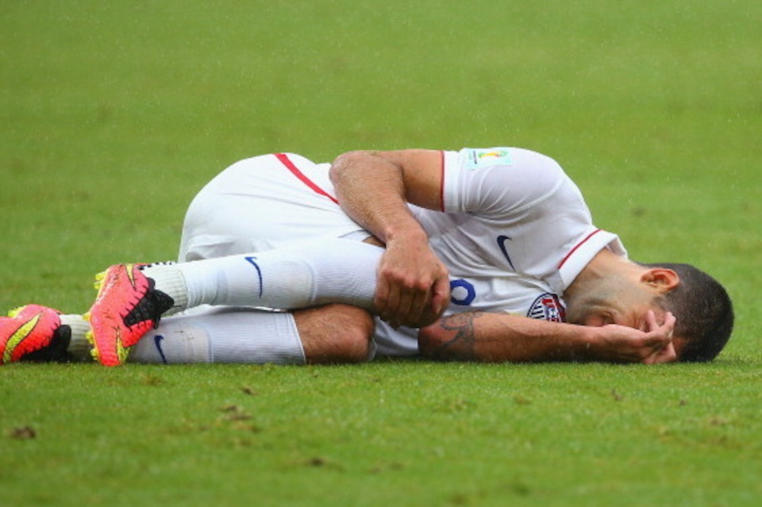RECIFE, BRAZIL - JUNE 26: Clint Dempsey of the United States lies on the field after a challenge during the 2014 FIFA World Cup Brazil group G match between the United States and Germany at Arena Pernambuco on June 26, 2014 in Recife, Brazil.  (Photo by R