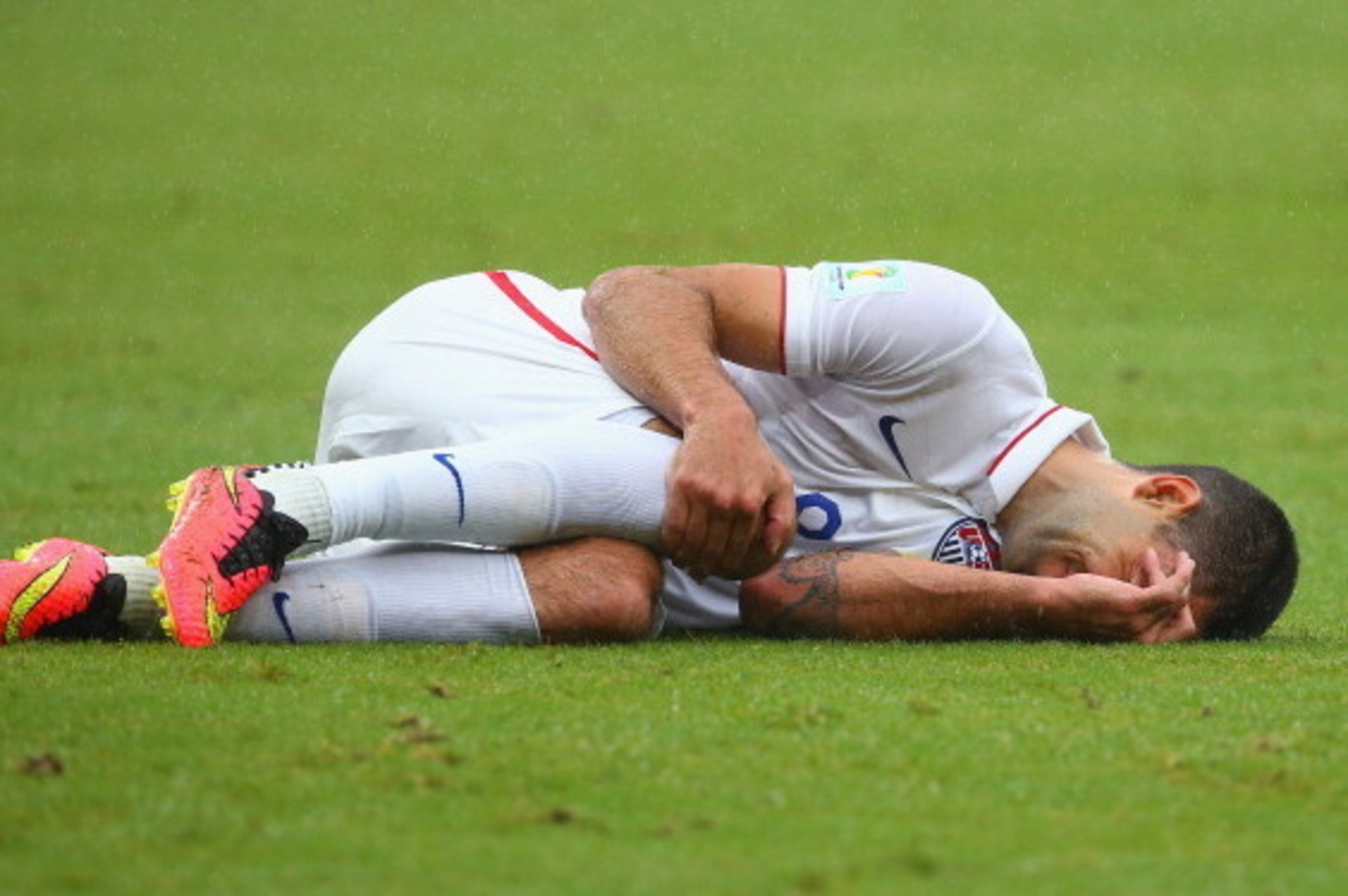 RECIFE, BRAZIL - JUNE 26: Clint Dempsey of the United States lies on the field after a challenge during the 2014 FIFA World Cup Brazil group G match between the United States and Germany at Arena Pernambuco on June 26, 2014 in Recife, Brazil.  (Photo by R