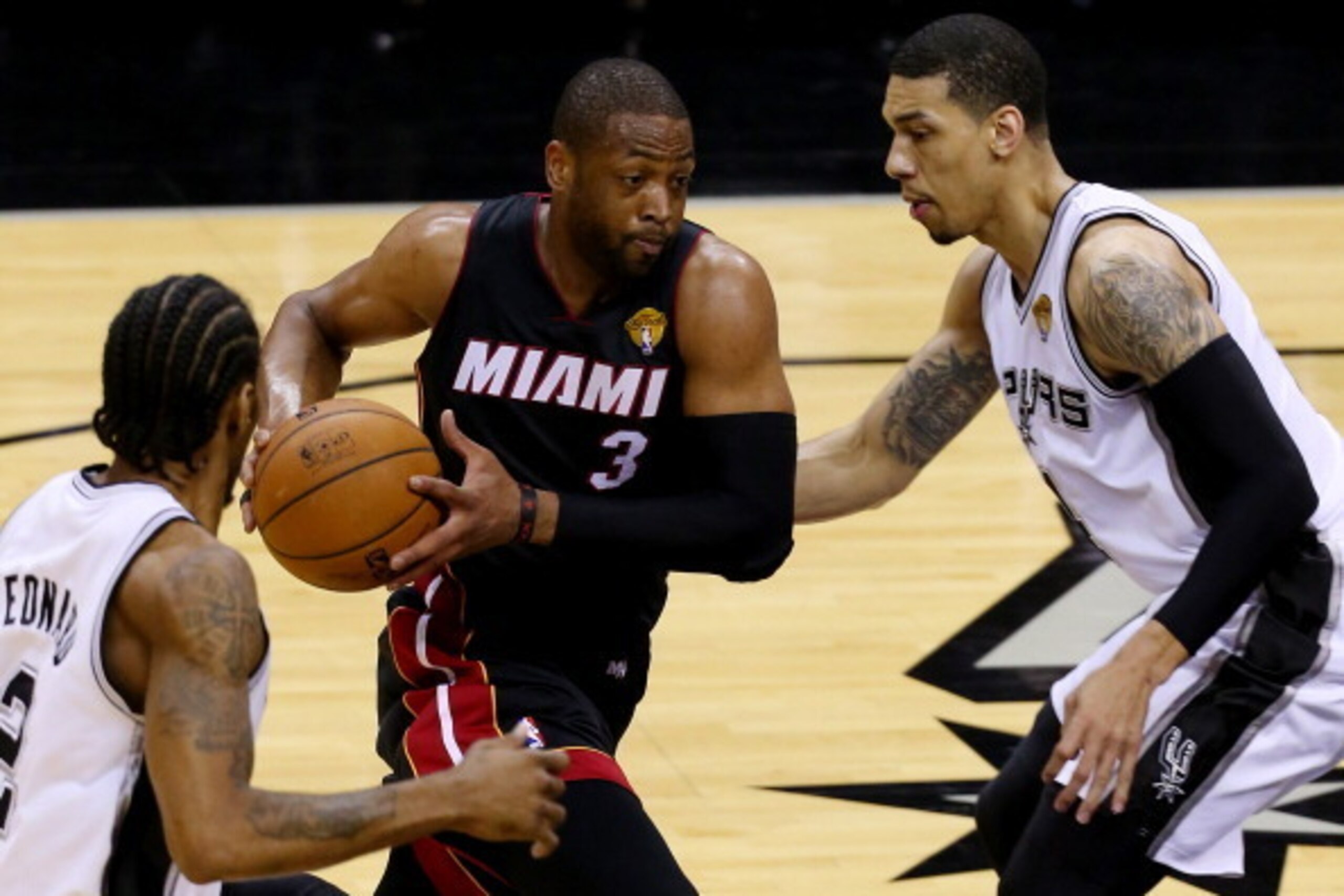 SAN ANTONIO, TX - JUNE 15: Dwyane Wade #3 of the Miami Heat drives to the basket against Danny Green #4 of the San Antonio Spurs during Game Five of the 2014 NBA Finals at the AT&T Center on June 15, 2014 in San Antonio, Texas. NOTE TO USER: User expressl