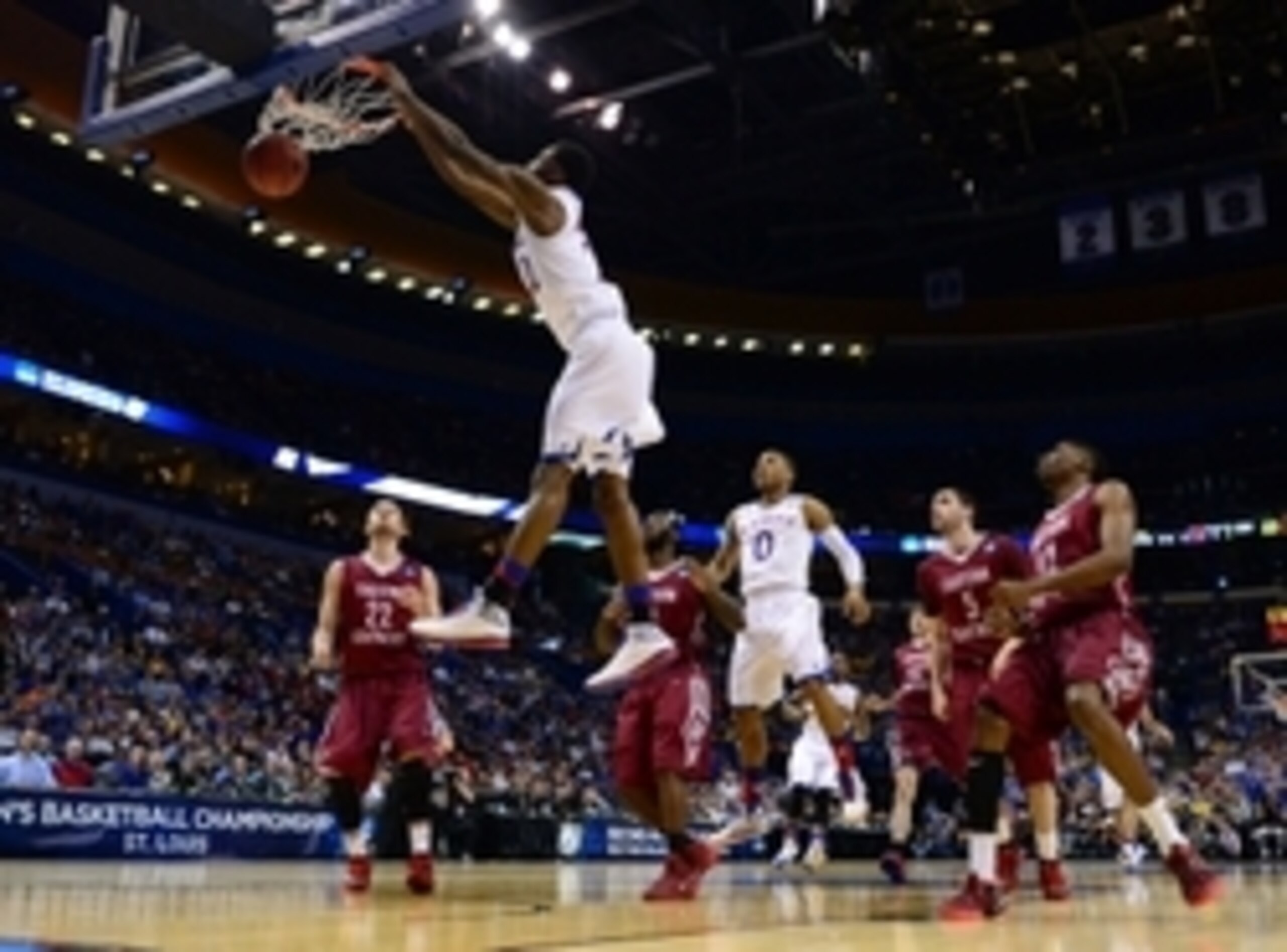Mar 21, 2014; St. Louis, MO, USA; Kansas Jayhawks guard Andrew Wiggins (22) dunks the ball ahead of Eastern Kentucky Colonels guard Isaac McGlone (5), Glenn Cosey (0) and Marcus Lewis (12) in the first half during the 2nd round of the 2014 NCAA Men's Bask