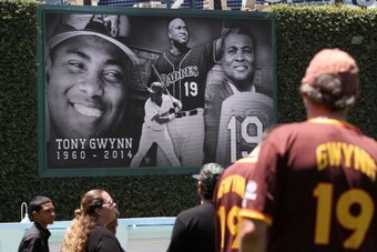SAN DIEGO, CA - JUNE 16:  San Diego Padre fans watch a tribute on a large screen at Petco Park to baseball great Tony Gwynn June 16, 2014 in San Diego, California. Gwynn died this morning after a lengthy battle with cancer, according to published reports.
