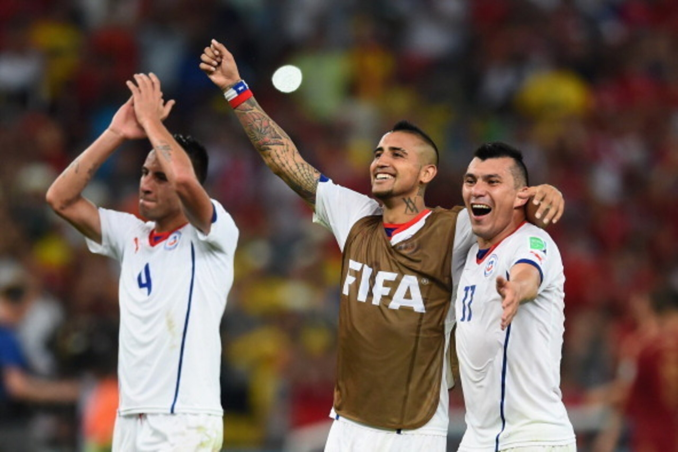 RIO DE JANEIRO, BRAZIL - JUNE 18:  Mauricio Isla, Arturo Vidal and Eduardo Vargas of Chile celebrate victory in the 2014 FIFA World Cup Brazil Group B match between Spain and Chile at Maracana on June 18, 2014 in Rio de Janeiro, Brazil.  (Photo by Matthia