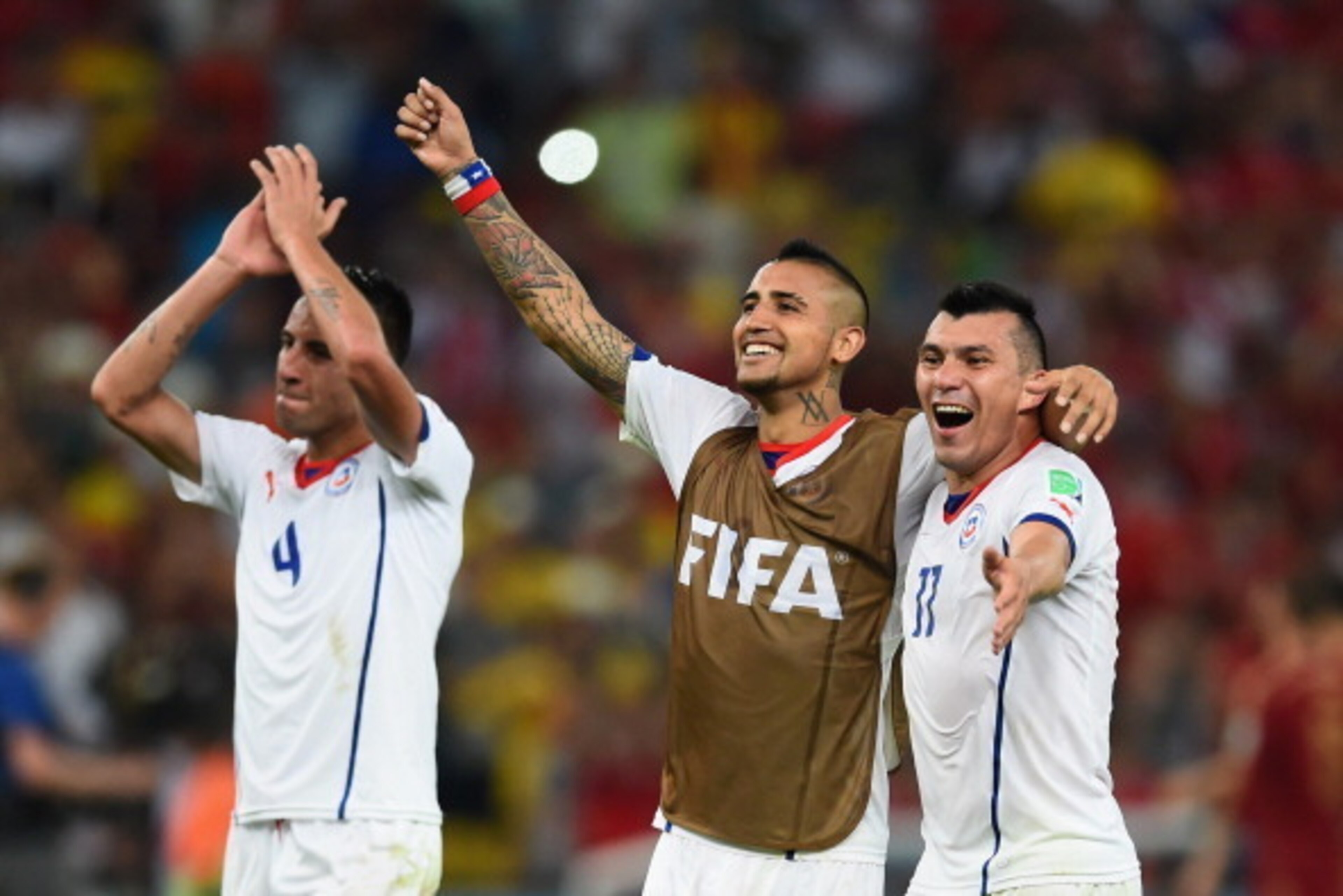 RIO DE JANEIRO, BRAZIL - JUNE 18:  Mauricio Isla, Arturo Vidal and Eduardo Vargas of Chile celebrate victory in the 2014 FIFA World Cup Brazil Group B match between Spain and Chile at Maracana on June 18, 2014 in Rio de Janeiro, Brazil.  (Photo by Matthia