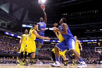 INDIANAPOLIS, IN - MARCH 30:  Julius Randle #30 of the Kentucky Wildcats shoots the ball over Jordan Morgan #52 of the Michigan Wolverines during the midwest regional final of the 2014 NCAA Men's Basketball Tournament at Lucas Oil Stadium on March 30, 201