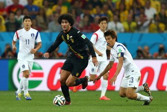 SAO PAULO, BRAZIL - JUNE 26:  Marouane Fellaini of Belgium and Koo Ja-Cheol of South Korea compete for the ball during the 2014 FIFA World Cup Brazil Group H match between South Korea and Belgium at Arena de Sao Paulo on June 26, 2014 in Sao Paulo, Brazil