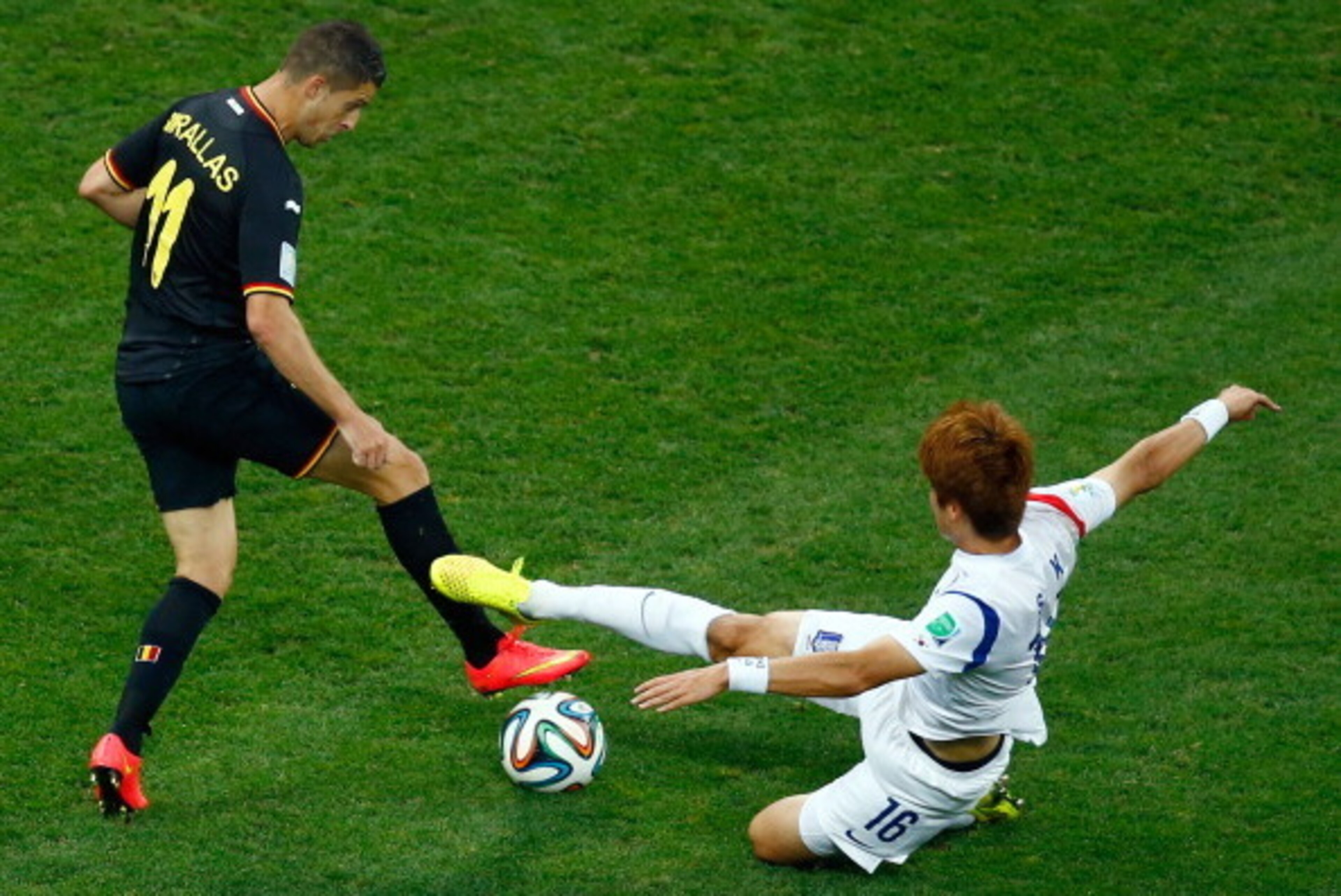 SAO PAULO, BRAZIL - JUNE 26:  Ki Sung-Yueng of South Korea tackles Kevin Mirallas of Belgium during the 2014 FIFA World Cup Brazil Group H match between South Korea and Belgium at Arena de Sao Paulo on June 26, 2014 in Sao Paulo, Brazil.  (Photo by Matthe