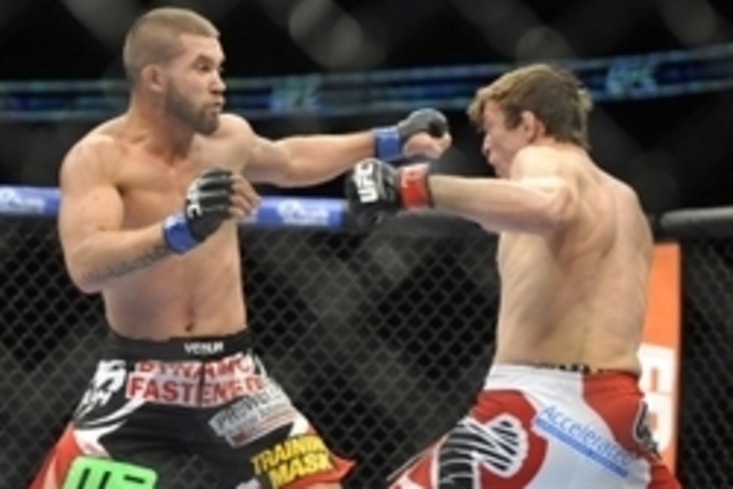 Jan 25, 2014; Chicago, IL, USA; Darren Elkins (red gloves) fights Jeremy Stephens (blue gloves) during UFC on FOX 10 at the United Center. Mandatory Credit: David Banks-USA TODAY Sports