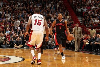 MIAMI, FL - JANUARY 23: Kyle Lowry #3 of the Toronto Raptors handles the ball up-court against Mario Chalmers #15 of the Miami Heat on January 23, 2013 at American Airlines Arena in Miami, Florida. NOTE TO USER: User expressly acknowledges and agrees that
