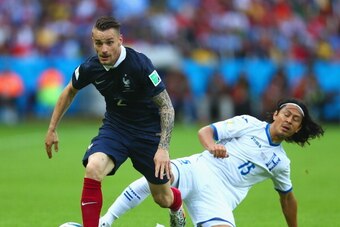 PORTO ALEGRE, BRAZIL - JUNE 15:  Mathieu Debuchy of France controls the ball against Roger Espinoza of Honduras during the 2014 FIFA World Cup Brazil Group E match between France and Honduras at Estadio Beira-Rio on June 15, 2014 in Porto Alegre, Brazil. 