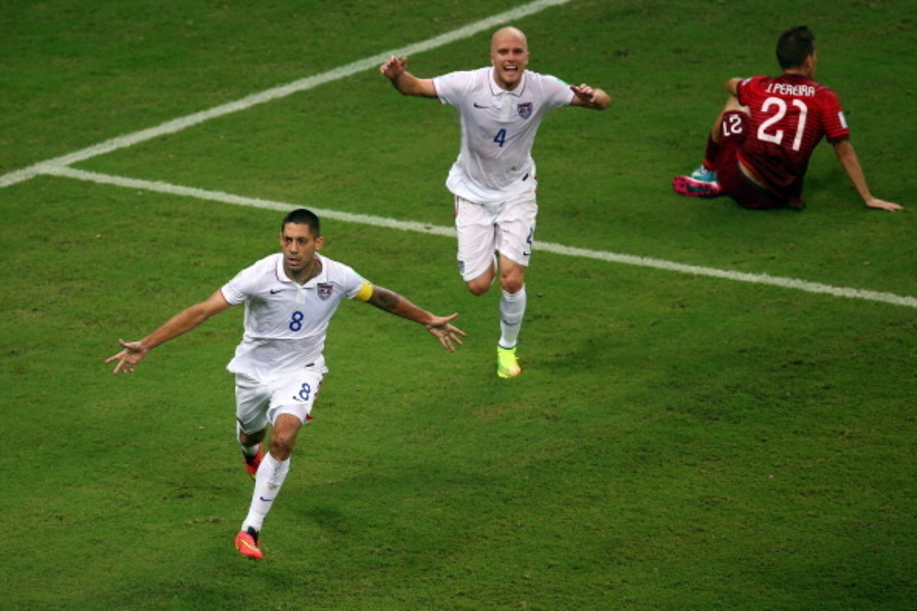 MANAUS, BRAZIL - JUNE 22: Clint Dempsey of the United States celebrates scoring his team's second goal with teammate Michael Bradley as Joao Pereira of Portugal looks on during the 2014 FIFA World Cup Brazil Group G match between the United States and Por