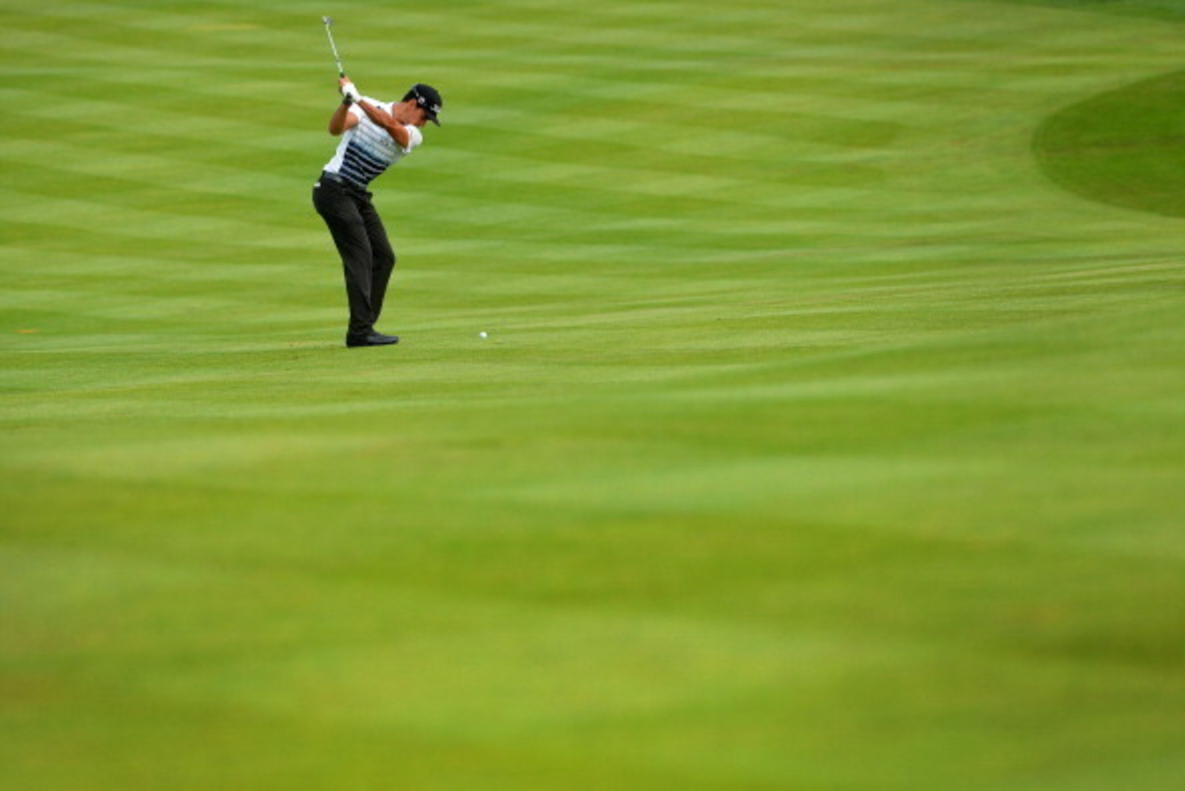 COLOGNE, GERMANY - June 27 : Rafa Cabrera-Bello of Spain plays his approach shot to the 14th green during the second round of the BMW International Open at Golf Club Gut Larchenhof on June 27, 2014 in Cologne, Germany. (Photo by Mark Runnacles/Getty Image
