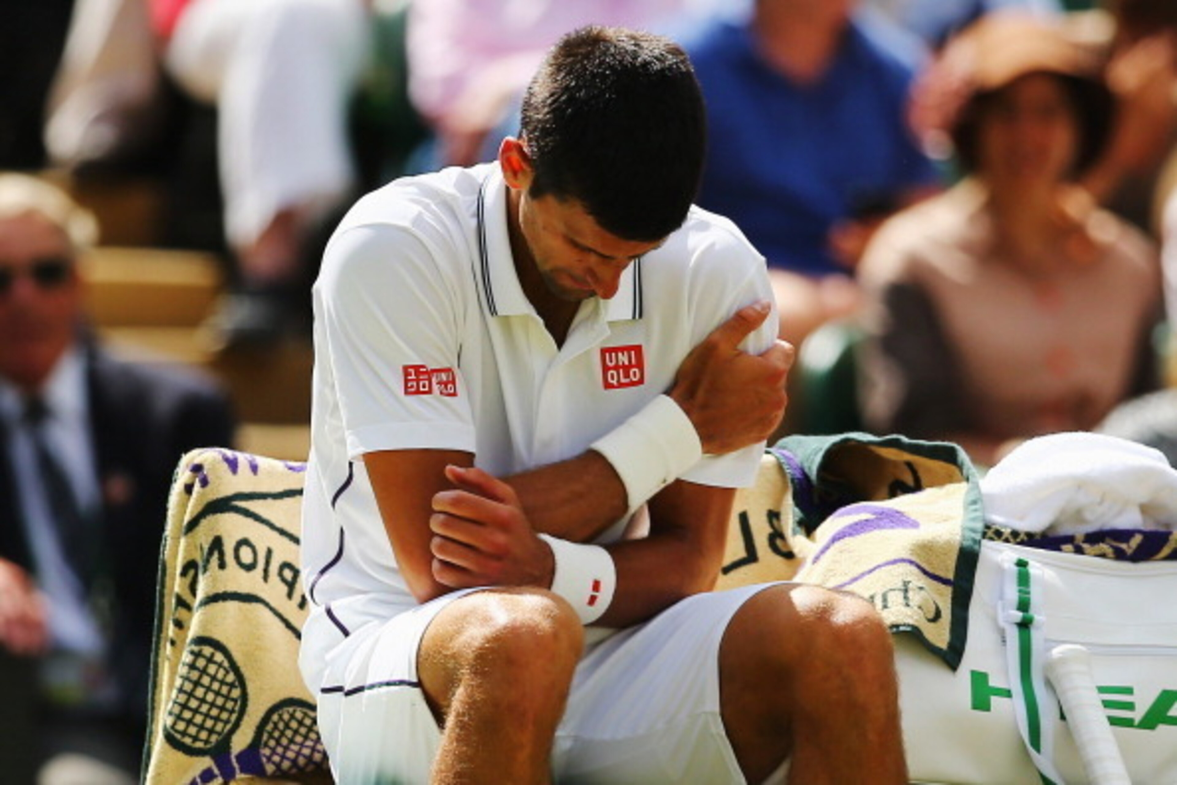LONDON, ENGLAND - JUNE 27:  Novak Djokovic of Serbia clutches his shoulder which he injured after a fall during his Gentlemen's Singles third round match against Gilles Simon of France on day five of the Wimbledon Lawn Tennis Championships at the All Engl