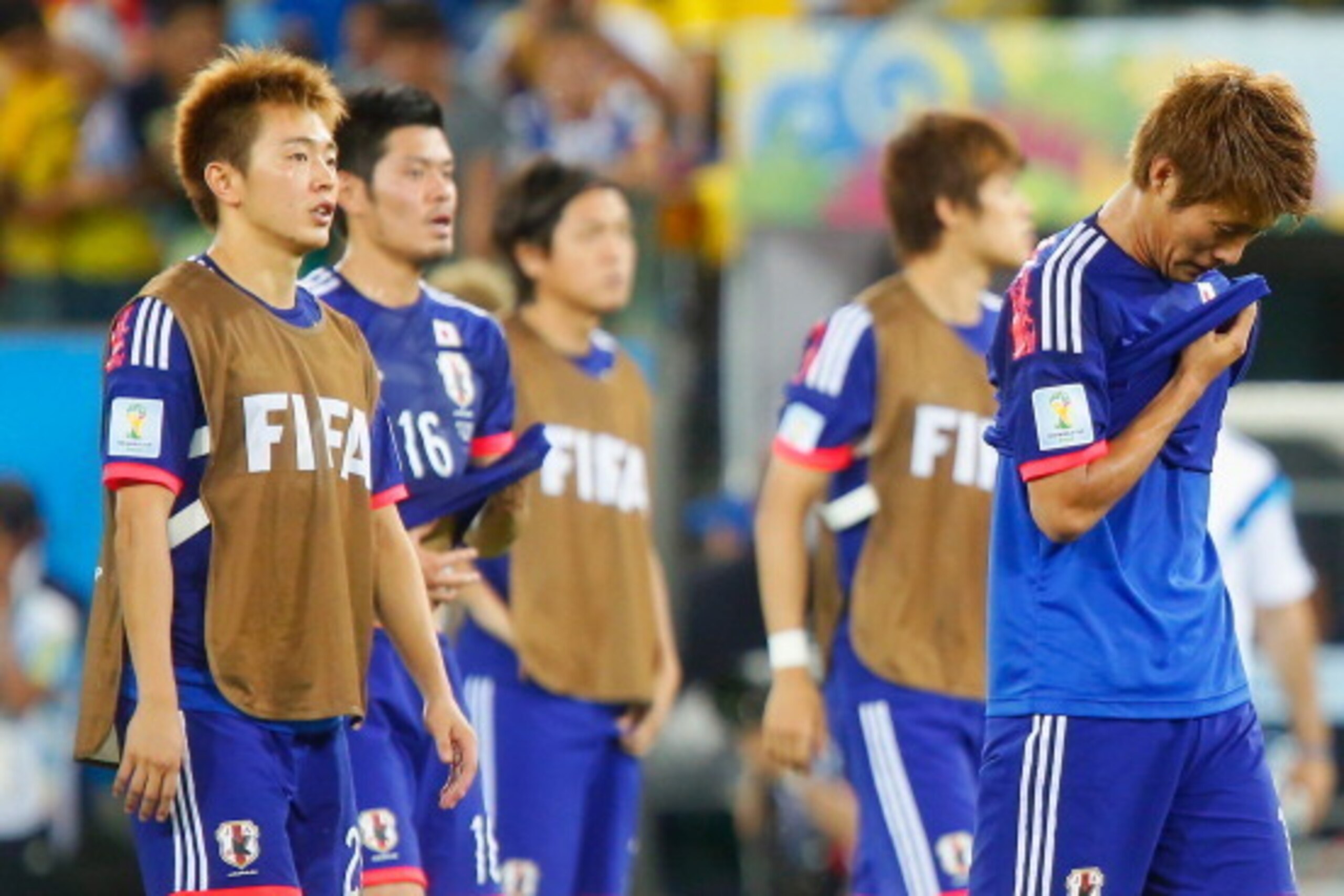 CUIABA, BRAZIL - JUNE 24:  A dejected Manabu Saito and Yoichiro Kakitani of Japan after defeat in the 2014 FIFA World Cup Brazil Group C match between Japan and Colombia at Arena Pantanal on June 24, 2014 in Cuiaba, Brazil.  (Photo by Gabriel Rossi/Getty 