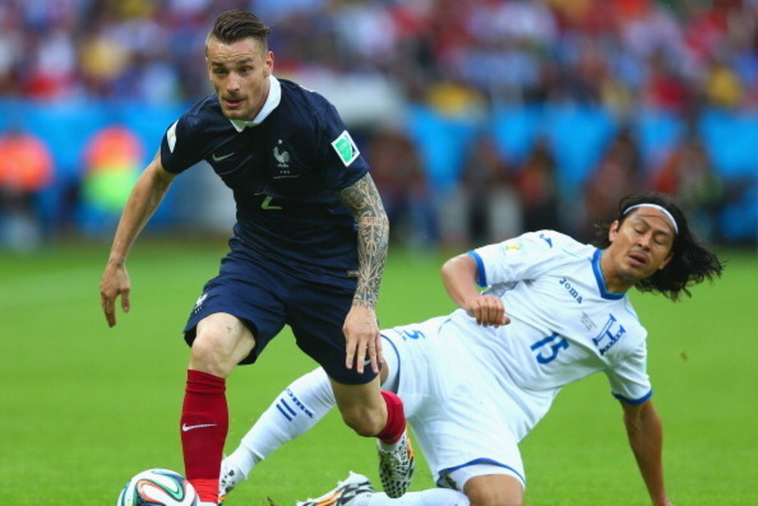 PORTO ALEGRE, BRAZIL - JUNE 15:  Mathieu Debuchy of France controls the ball against Roger Espinoza of Honduras during the 2014 FIFA World Cup Brazil Group E match between France and Honduras at Estadio Beira-Rio on June 15, 2014 in Porto Alegre, Brazil. 