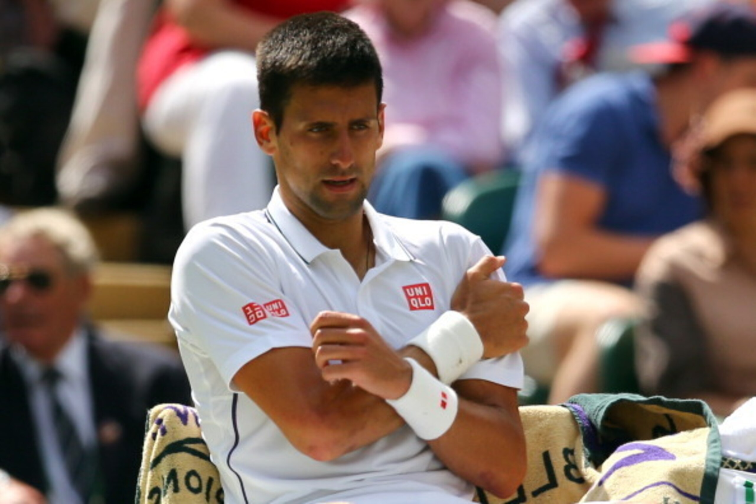 LONDON, ENGLAND - JUNE 27:  Novak Djokovic of Serbia clutches his shoulder which he injured after a fall during his Gentlemen's Singles third round match against Gilles Simon of France on day five of the Wimbledon Lawn Tennis Championships at the All Engl