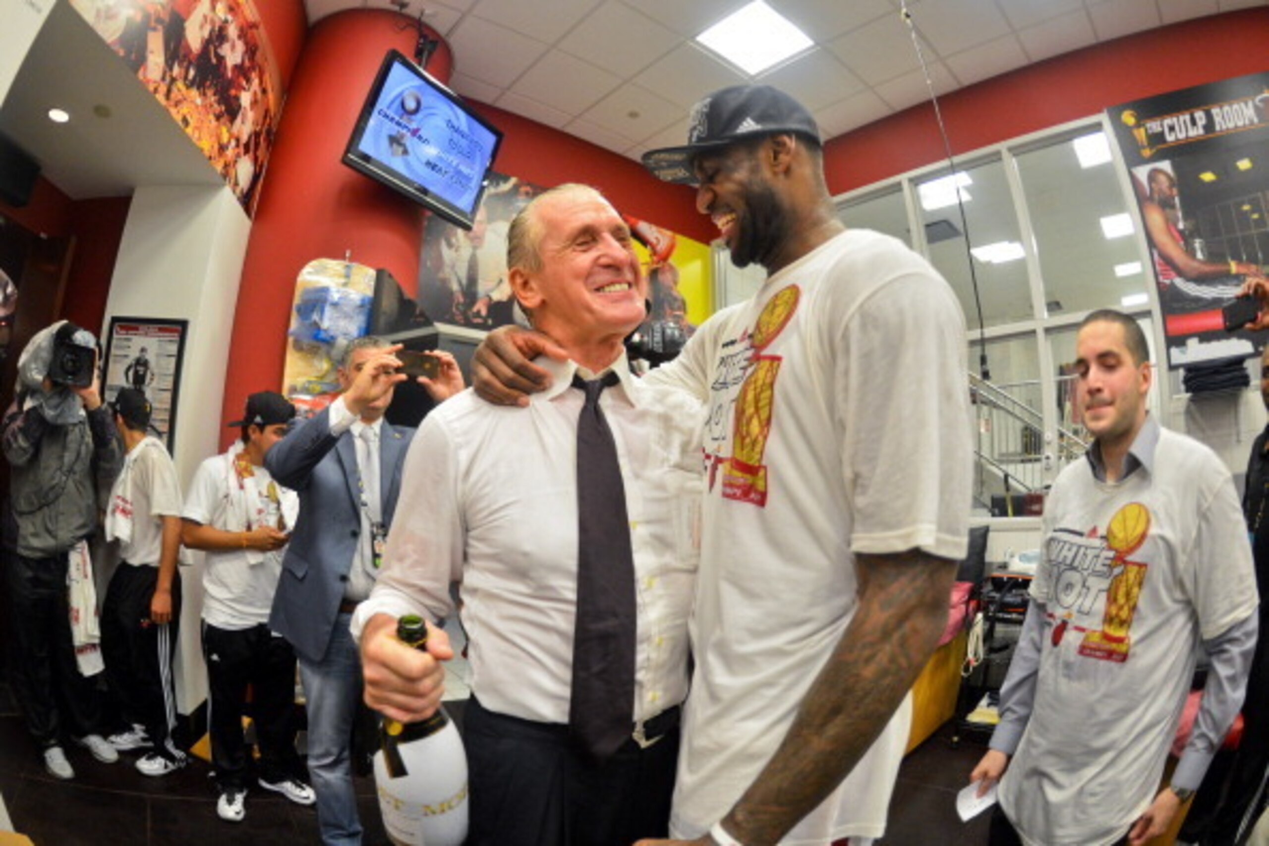 MIAMI, FL - JUNE 20: LeBron James #6 of the Miami Heat celebrates with team President Pat Riley in the locker room following the Heat's victory against the San Antonio Spurs in Game Seven of the 2013 NBA Finals on June 20, 2013 at American Airlines Arena 