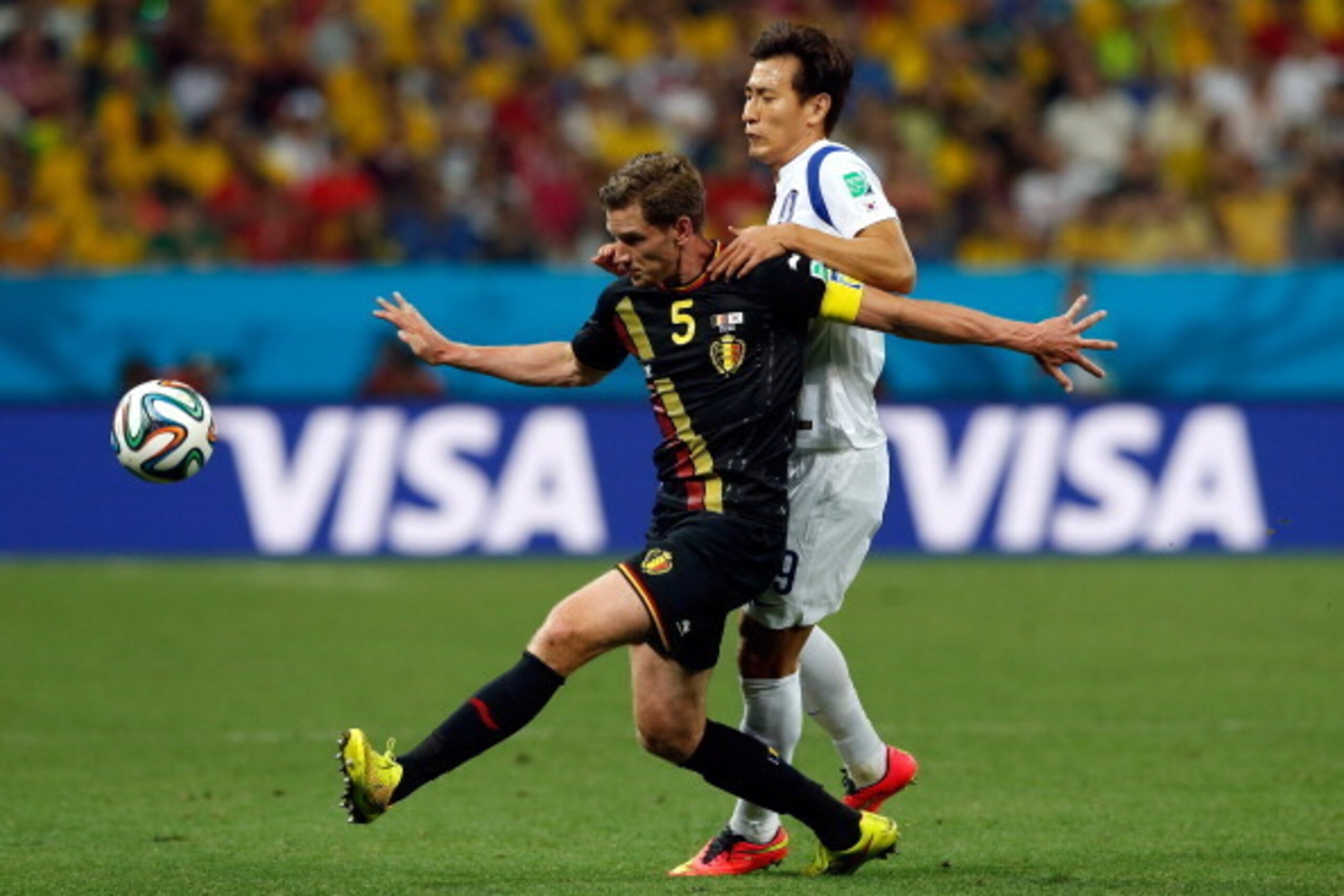 SAO PAULO, BRAZIL - JUNE 26:  Jan Vertonghen of Belgium fights off Ji Dong-Won of South Korea  during the 2014 FIFA World Cup Brazil Group H match between South Korea and Belgium at Arena de Sao Paulo on June 26, 2014 in Sao Paulo, Brazil.  (Photo by Alex