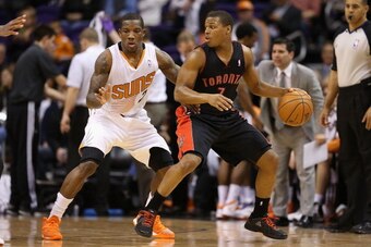 PHOENIX, AZ - DECEMBER 06:  Kyle Lowry #7 of the Toronto Raptors handles the ball guarded by Eric Bledsoe #2 of the Phoenix Suns during the NBA game at US Airways Center on December 6, 2013 in Phoenix, Arizona. The Suns defeated the Raptors 106-97.  NOTE 