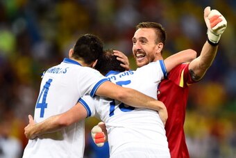 FORTALEZA, BRAZIL - JUNE 24:  (L-R) Konstantinos Manolas, Vasilis Torosidis and Panagiotis Glykos of Greece celebrate after defeating the Ivory Coast 2-1 during the 2014 FIFA World Cup Brazil Group C match between Greece and the Ivory Coast at Castelao on