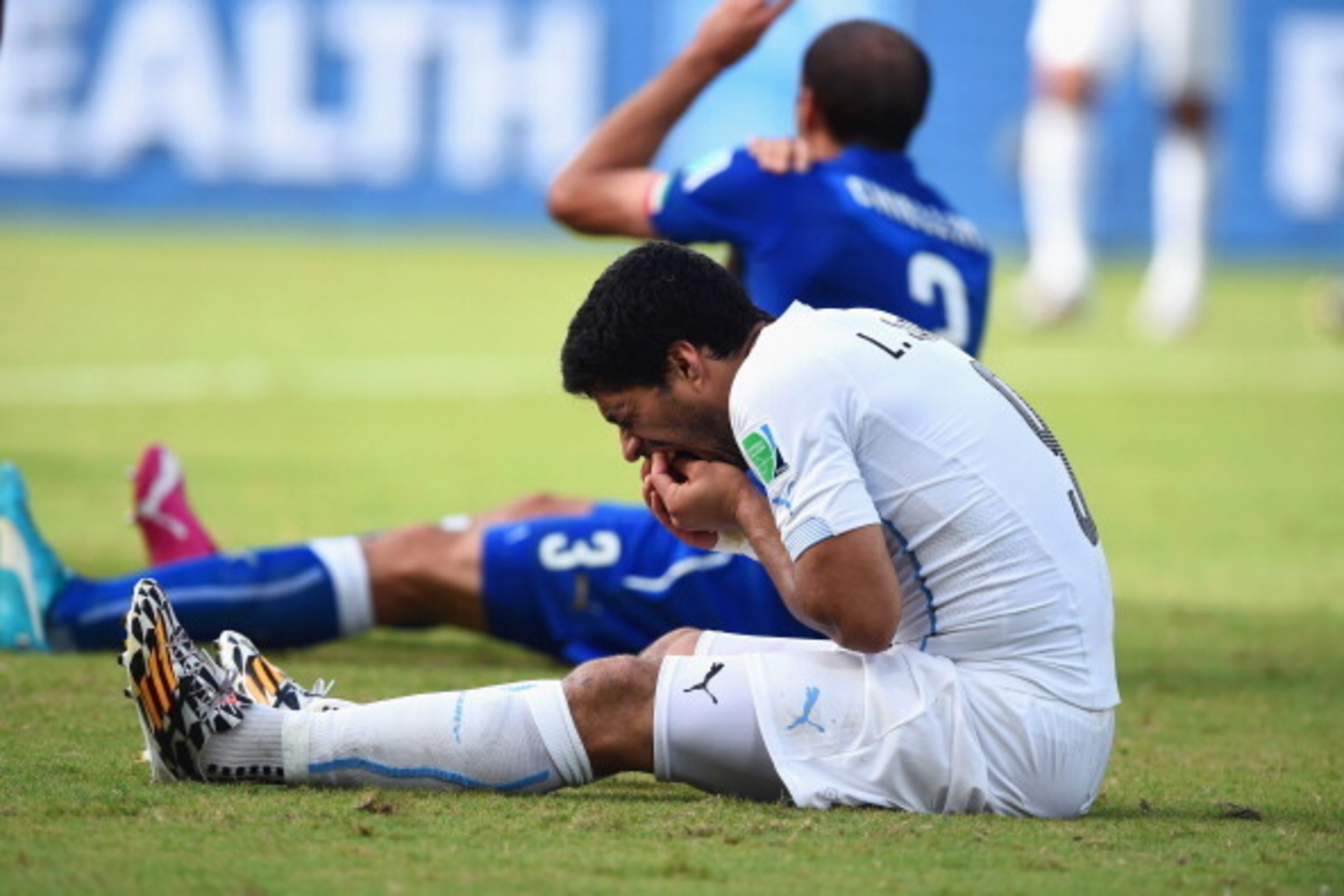 NATAL, BRAZIL - JUNE 24:  Luis Suarez of Uruguay and Giorgio Chiellini of Italy react after a clash during the 2014 FIFA World Cup Brazil Group D match between Italy and Uruguay at Estadio das Dunas on June 24, 2014 in Natal, Brazil.  (Photo by Matthias H