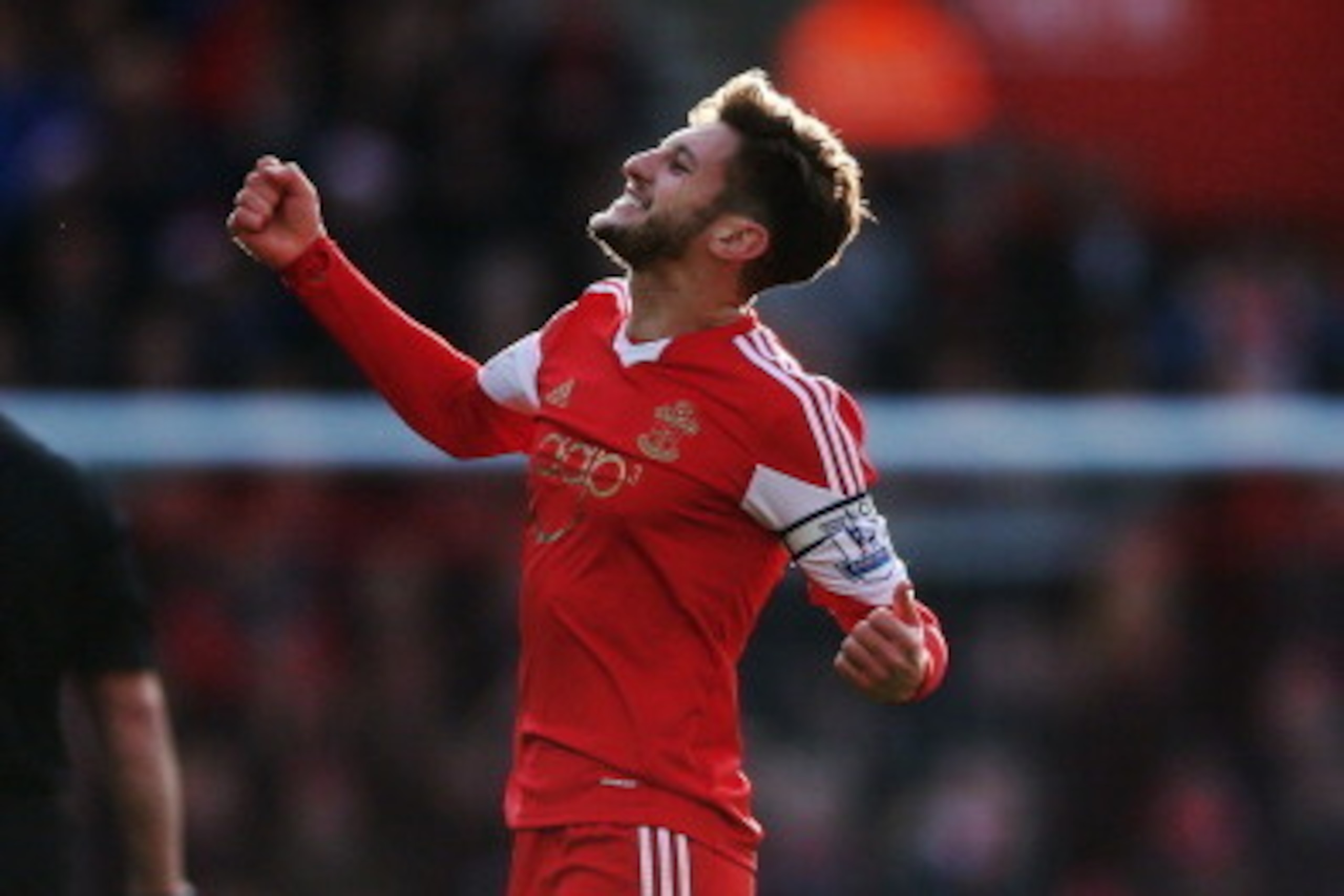 SOUTHAMPTON, ENGLAND - DECEMBER 22:  Adam Lallana of Southampton celebrates after scoring the opening goal during the Barclays Premier League match between Southampton and Tottenham Hotspur at St Mary's Stadium on December 22, 2013 in Southampton, England