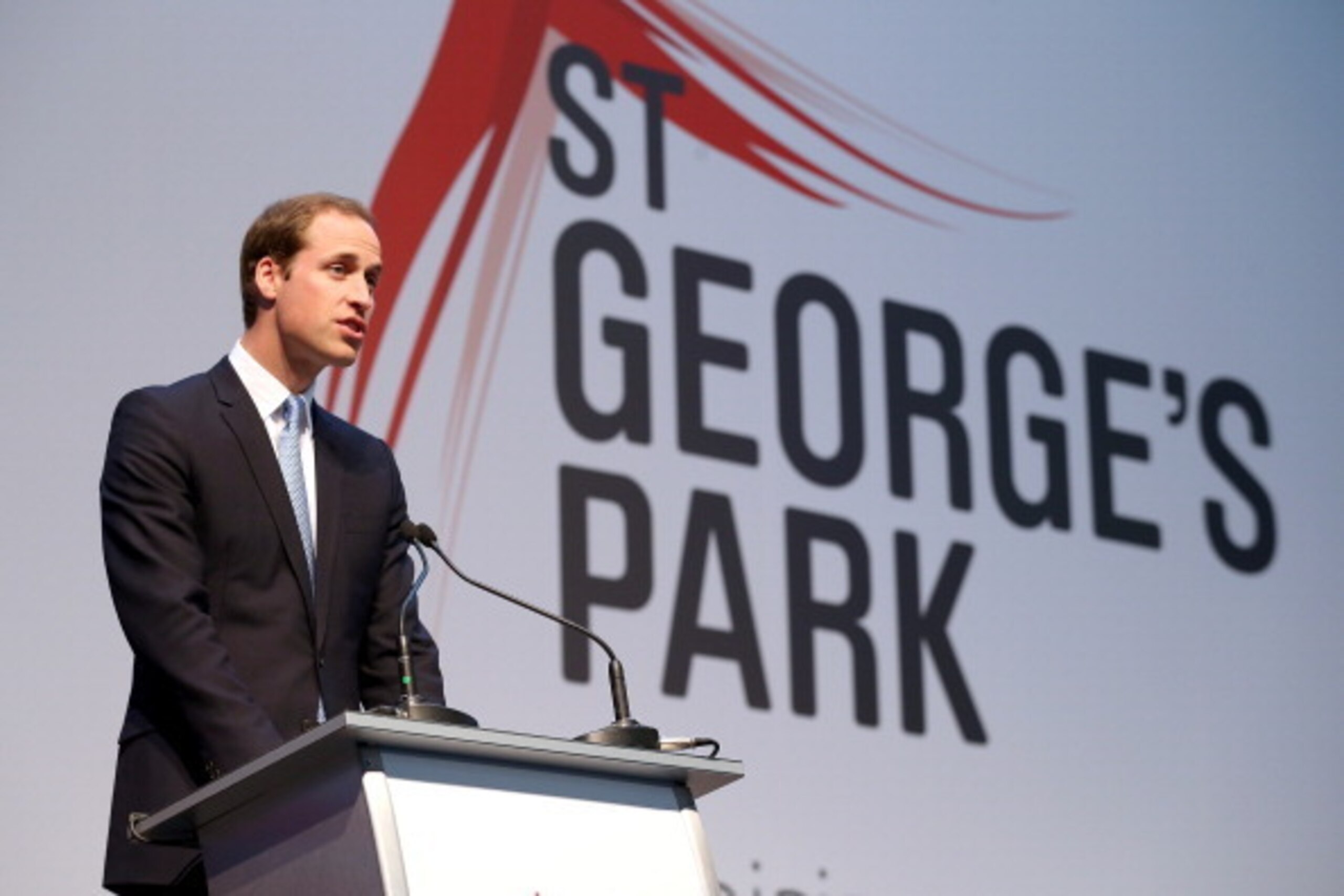 BURTON-UPON-TRENT, ENGLAND - OCTOBER 09:  Prince William, Duke of Cambridge gives a speech as  Catherine, Duchess of Cambridge looks on during the official launch of The Football Association's National Football Centre at St George's Park on October 9, 201