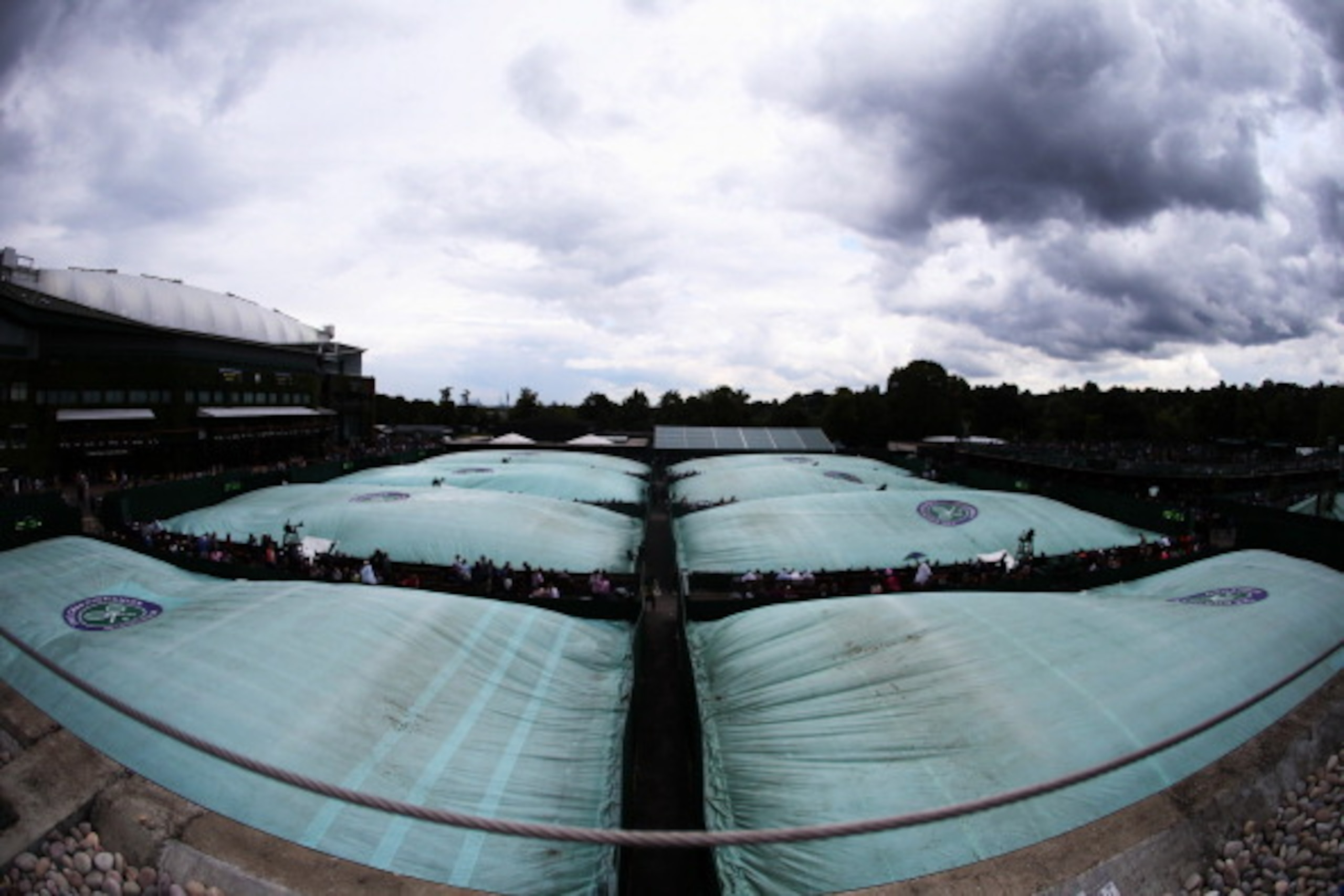 LONDON, ENGLAND - JUNE 28:  A general view of the rain covers on the outside courts on day six of the Wimbledon Lawn Tennis Championships at the All England Lawn Tennis and Croquet Club at Wimbledon on June 28, 2014 in London, England.  (Photo by Jan Krug