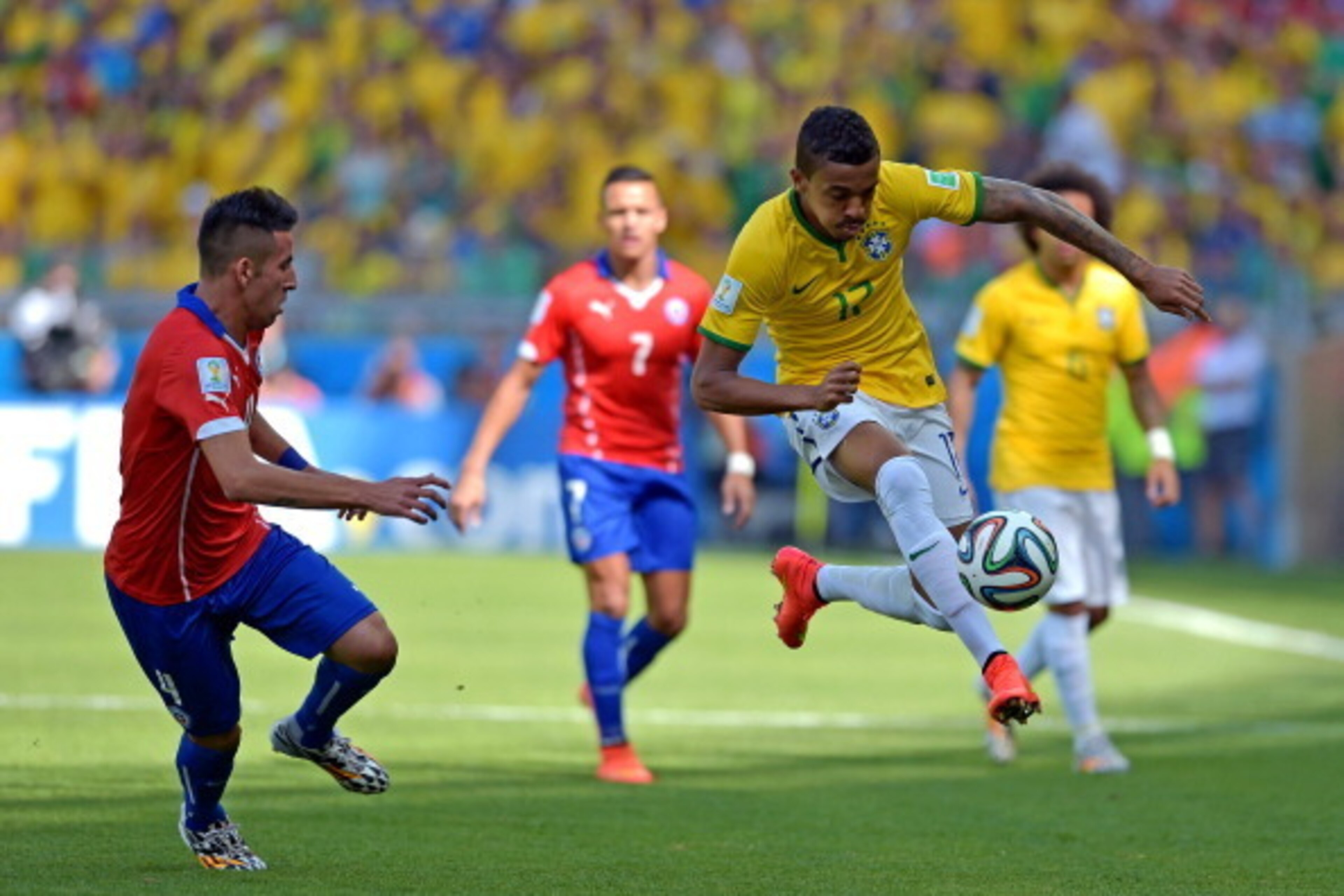 BELO HORIZONTE, BRAZIL - JUNE 28: Luiz Gustavo of Brazil controls the ball against Mauricio Isla of Chile during the 2014 FIFA World Cup Brazil round of 16 match between Brazil and Chile at Estadio Mineirao on June 28, 2014 in Belo Horizonte, Brazil.  (Ph