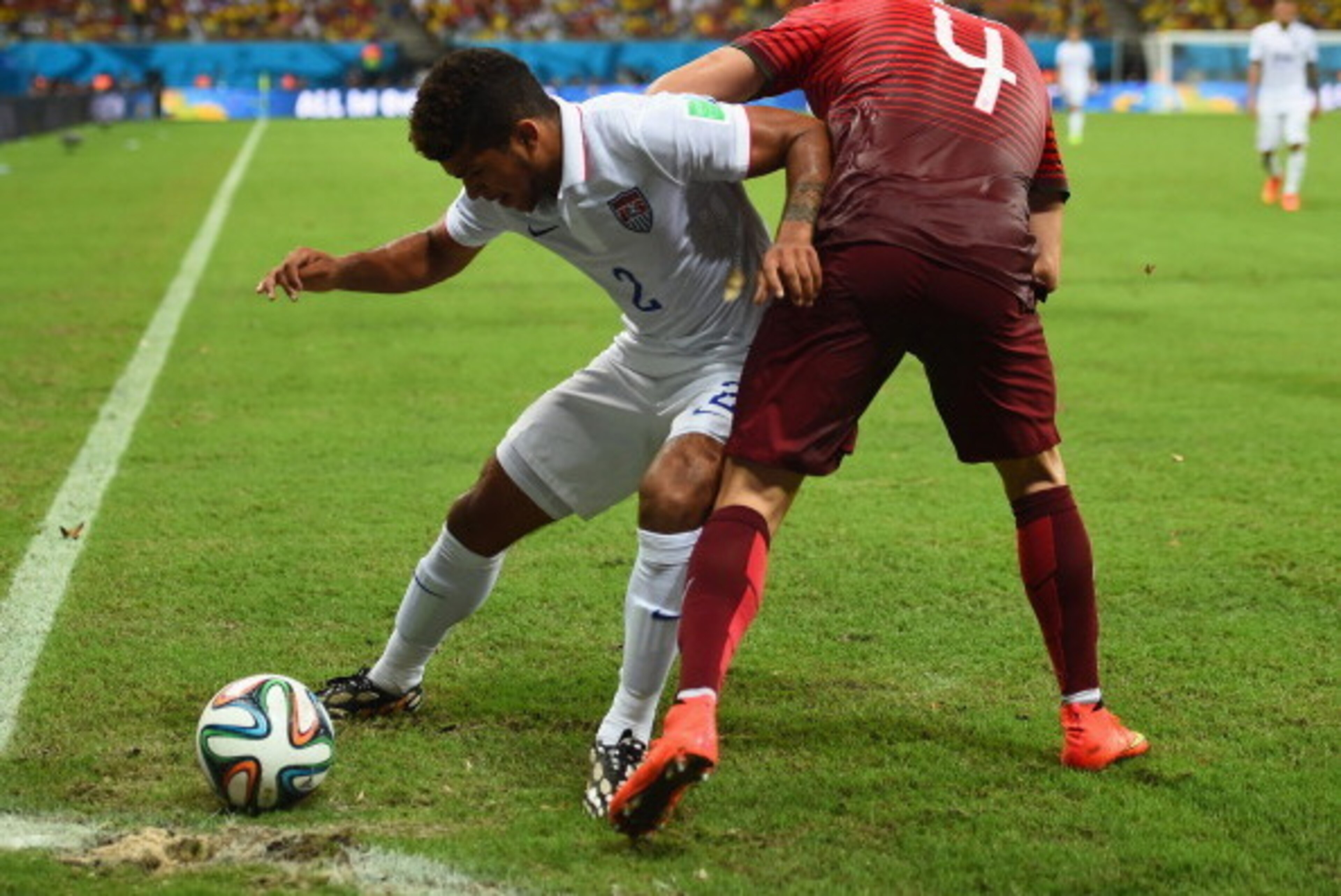 MANAUS, BRAZIL - JUNE 22:  DeAndre Yedlin of the United States and Miguel Veloso of Portugal compete for the ball during the 2014 FIFA World Cup Brazil Group G match between the United States and Portugal at Arena Amazonia on June 22, 2014 in Manaus, Braz
