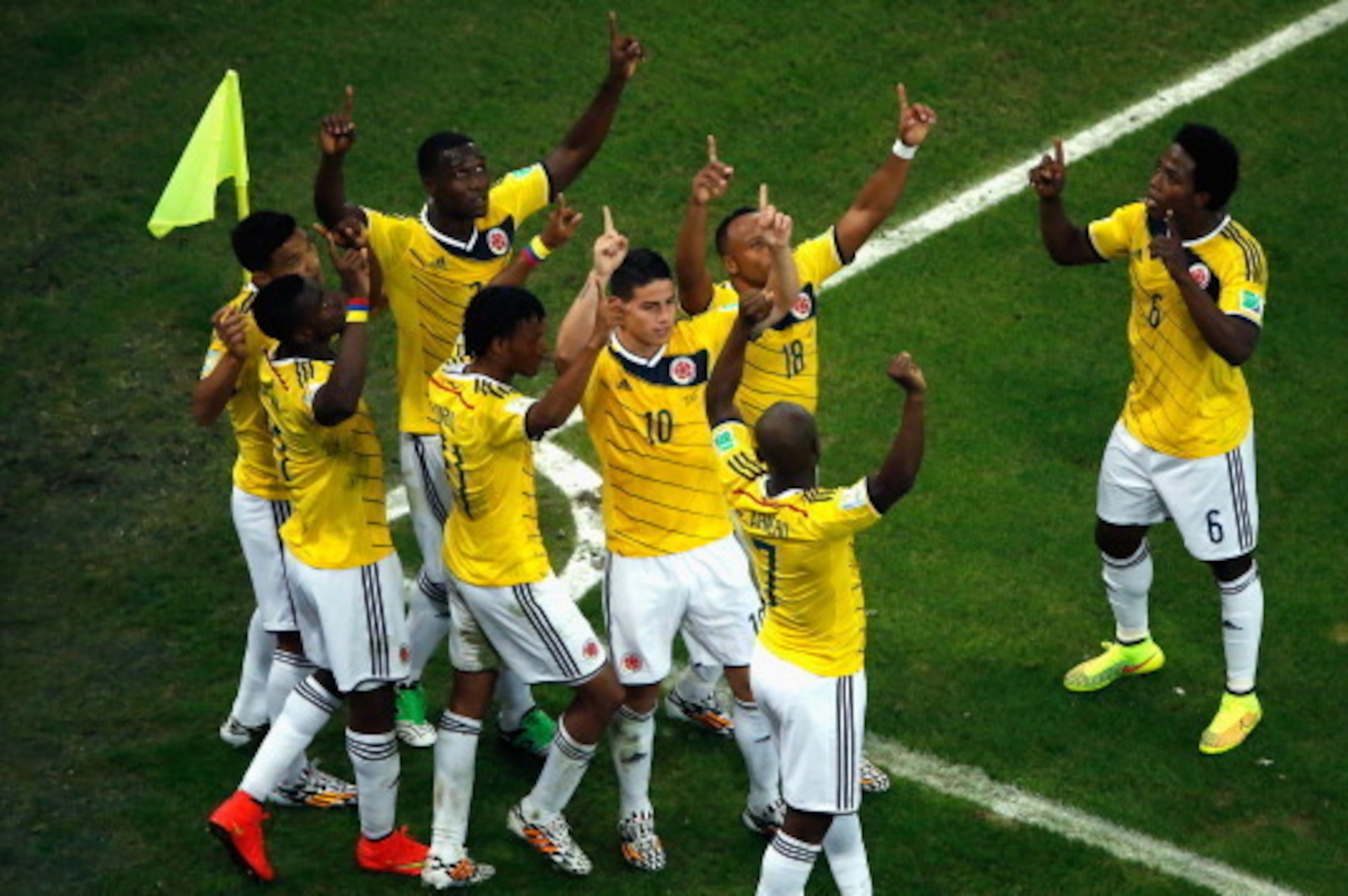 RIO DE JANEIRO, BRAZIL - JUNE 28:  James Rodriguez of Colombia celebrates scoring his team's second goal and his second of the game with teammates during the 2014 FIFA World Cup Brazil round of 16 match between Colombia and Uruguay at Maracana on June 28,