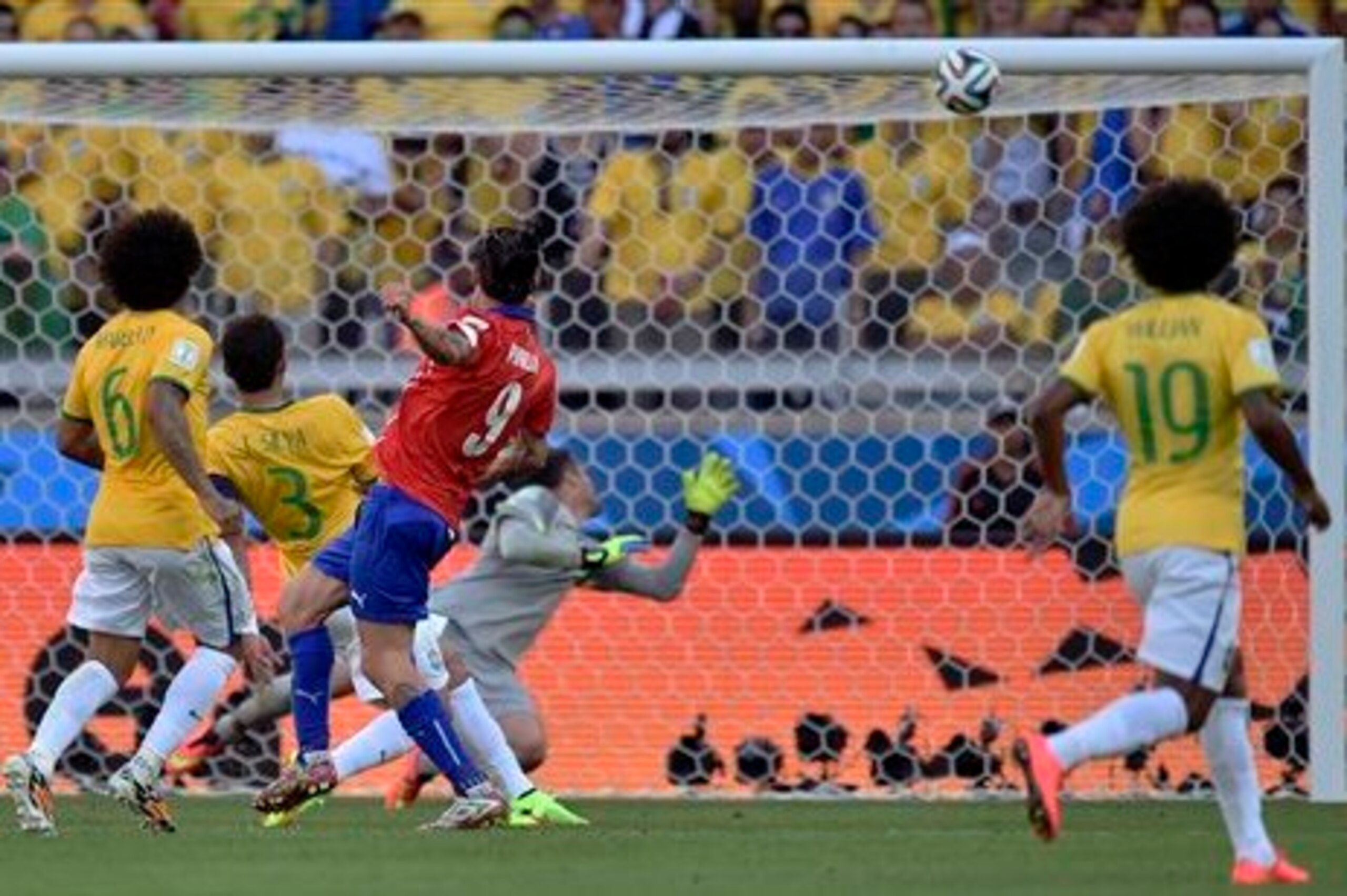 Pinilla's shot hits the bar late.