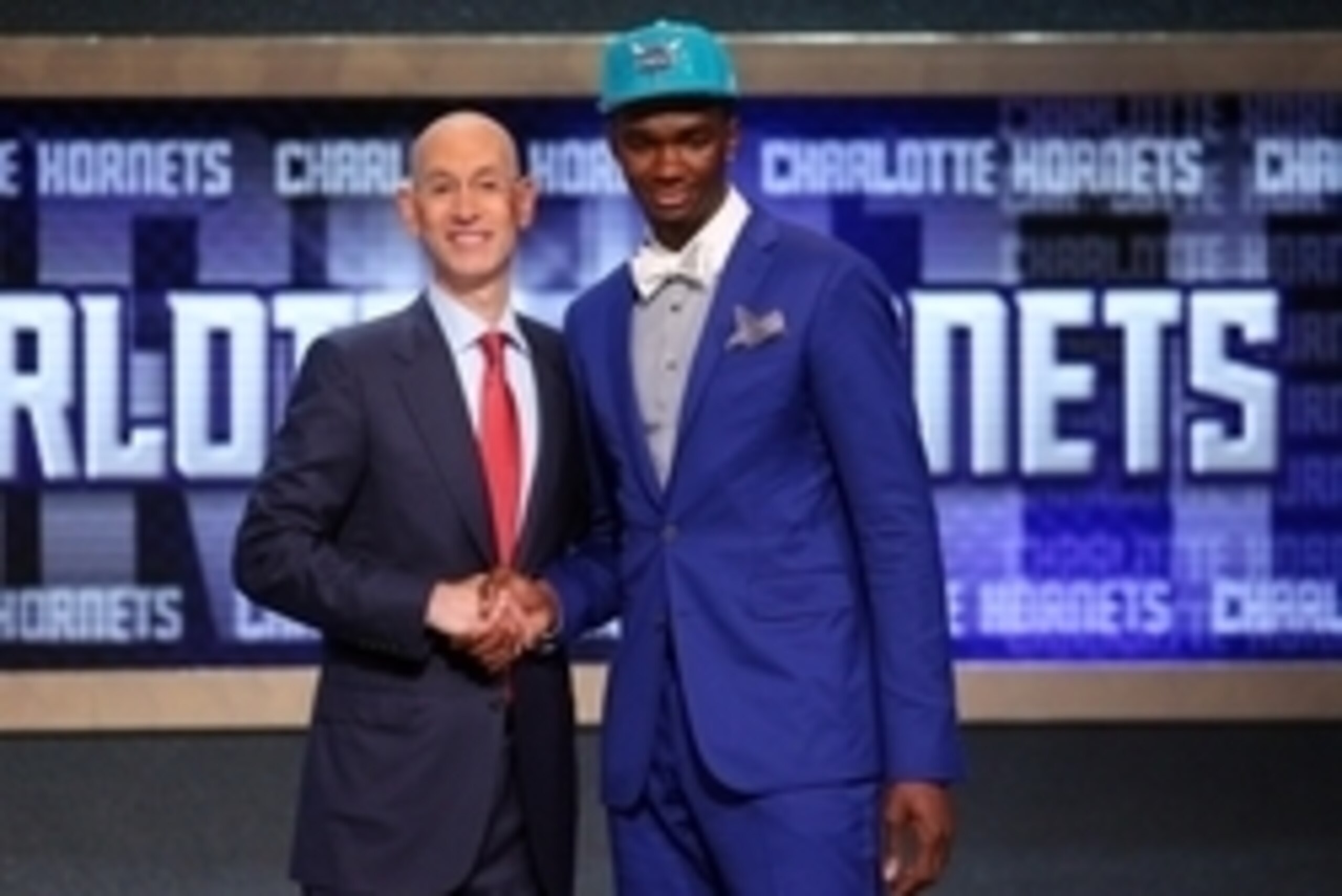 Jun 26, 2014; Brooklyn, NY, USA; Noah Vonleh (Indiana) shakes hands with NBA commissioner Adam Silver after being selected as the number nine overall pick to the Charlotte Hornets in the 2014 NBA Draft at the Barclays Center. Mandatory Credit: Brad Penner
