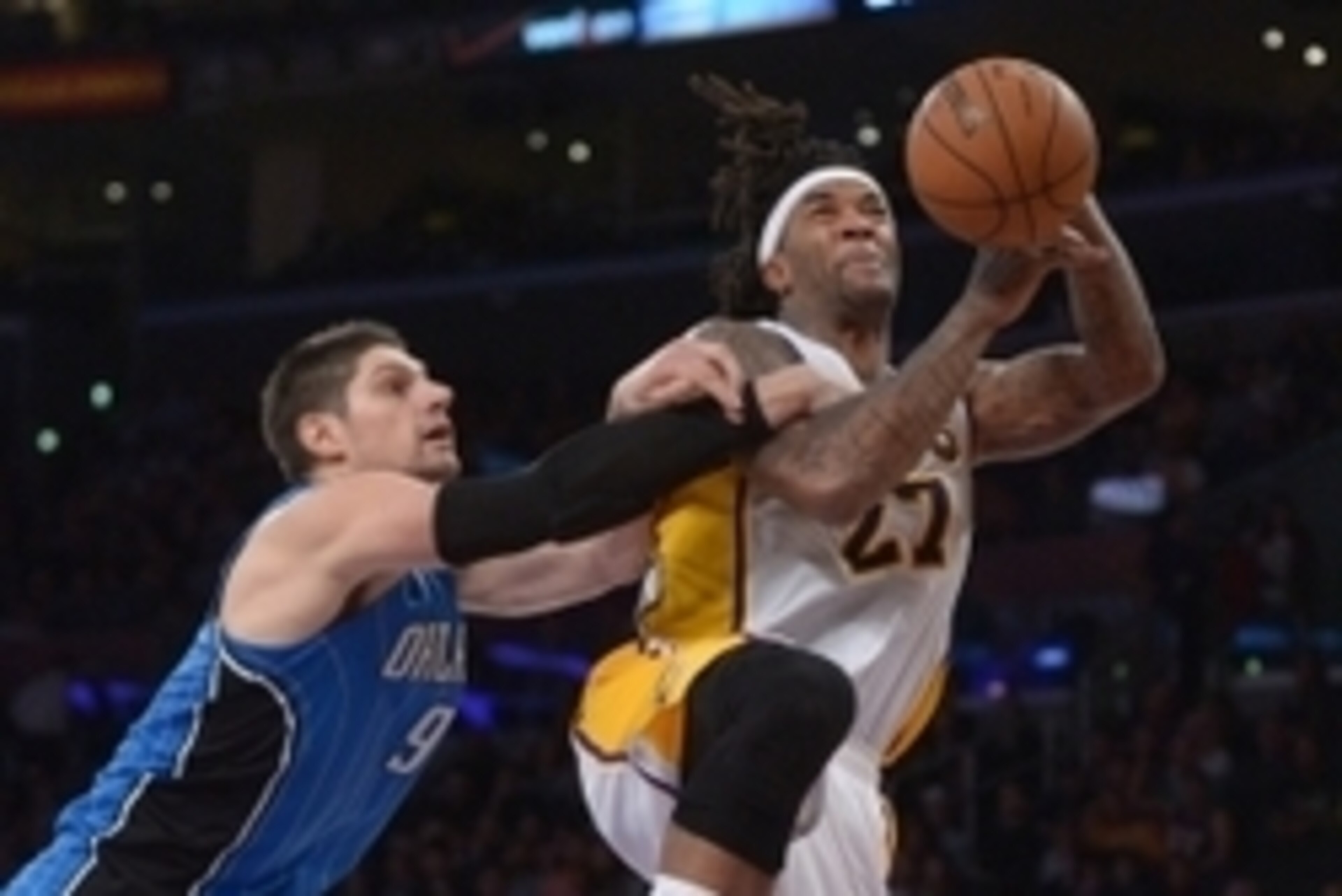 Mar 23, 2014; Los Angeles, CA, USA; Los Angeles Lakers forward Jordan Hill (27) is fouled by Orlando Magic center Nikola Vucevic (9) at Staples Center. The Lakers won 103-94. Mandatory Credit: Kirby Lee-USA TODAY Sports