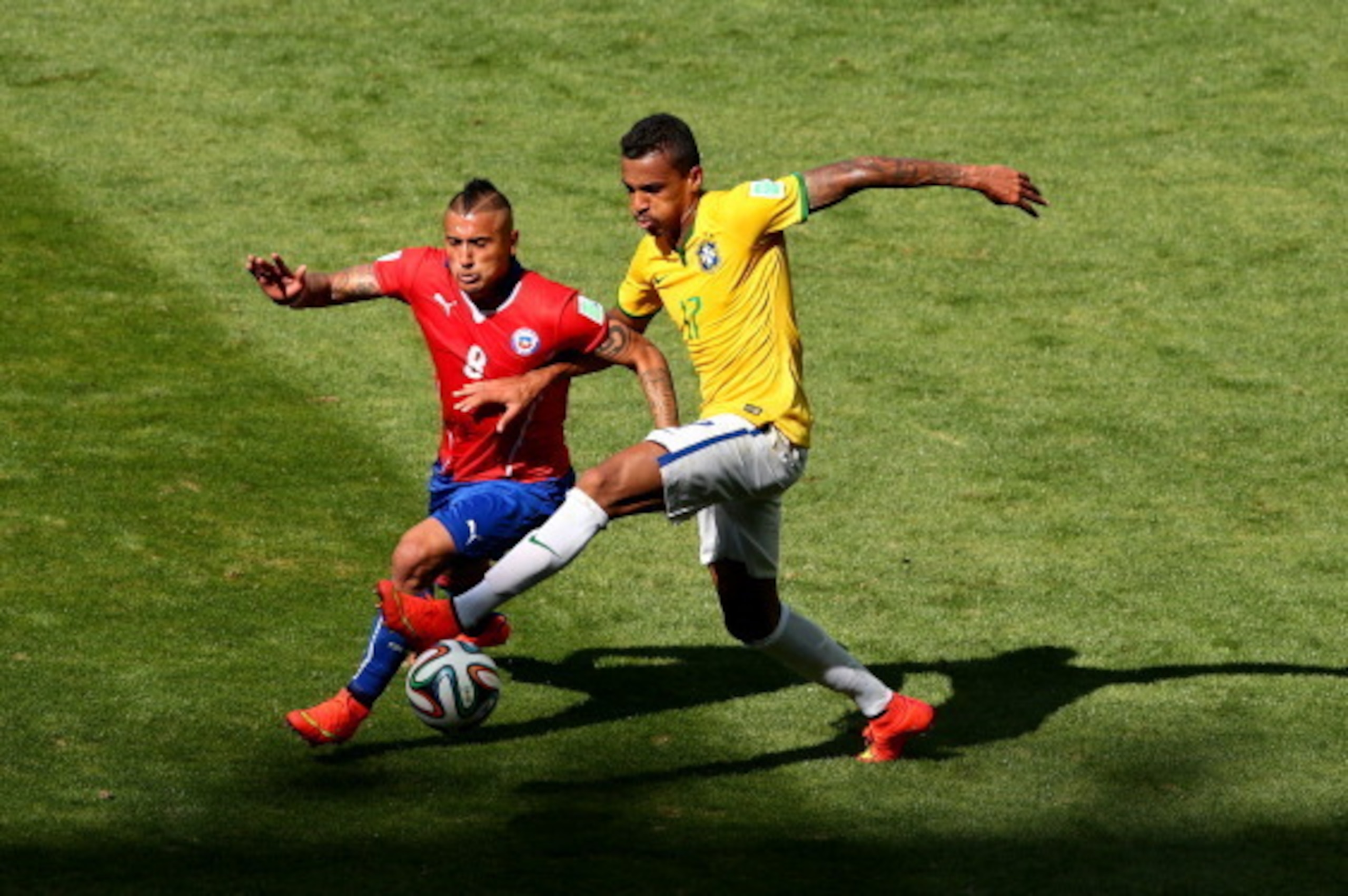 BELO HORIZONTE, BRAZIL - JUNE 28:  Arturo Vidal of Chile and Luiz Gustavo of Brazil compete for the ball during the 2014 FIFA World Cup Brazil round of 16 match between Brazil and Chile at Estadio Mineirao on June 28, 2014 in Belo Horizonte, Brazil.  (Pho